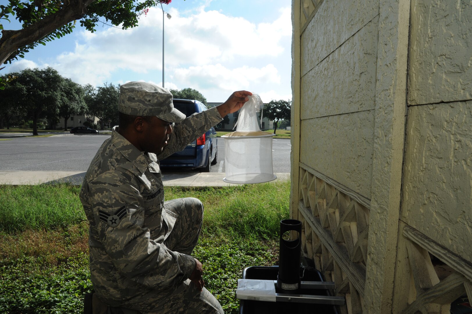 Senior Airman Shannon Anderson, 359th Aerospace Medicine Squadron public health technician, collects mosquitoes July 11 at the Joint Base San Antonio-Randolph Bowling Center. Once collected, the mosquitoes are tested for West Nile virus. (U.S. Air Force photo by Rich McFadden/released)

