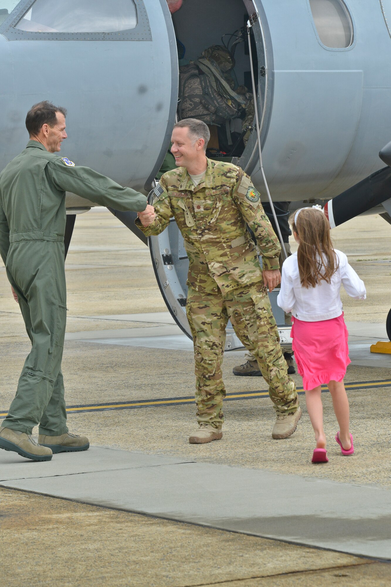 Air Force Lt. Gen. Stanley E. Clarke III, director of the Air National Guard, greets Maj. Stan Coleman, 130th Air Wing, West Virginia ANG, and other Air Force RC-26 aircraft crewmembers after landing at Joint Base Andrews, Md., July 12, 2013, as they return from operations in Southwest Asia and the Area of Responsibility. The RC-26 aircraft, a highly mobile intelligence, surveillance, and reconnaissance platform flown solely by the ANG and operated under the 45th Expeditionary Special Operations Squadron, provided U.S. Special Operations Command with more than 45,000 combat hours flown in support of Operation Iraqi Freedom, Operation Enduring Freedom, and Operation New Dawn that resulted in Air Guardsmen receiving more than 1,000 Air Medals, 15 Bronze Star Medals, and 15 Combat Action Medals for ANG personnel. (U.S. Air National Guard photo by Master Sgt. Dennis Young/RELEASED)