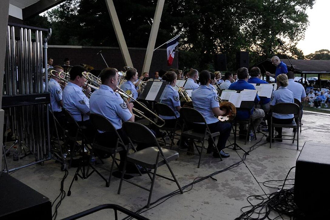 Jim Crowder, conductor of the Bettendorf City Band, takes the podium to direct "National Emblem".  Members of the City Band joined the 566th for the last few numbers of the concert.

Photo courtesy of TSgt Todd Pendleton, 182nd AW