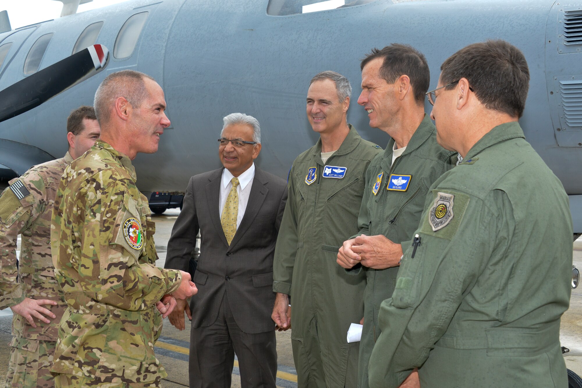 (Left to right) Air Force Lt. Col. Glen Dubois, 174th Fighter Wing, New York Air National Guard, and Capt. Andrew Jerry, 193rd Special Operations Wing, Pennsylvania ANG, talk with Richard F. Rico, director of staff of the Air National Guard Readiness Center, Brig. Gen. R. Scott Williams, commander of the ANGRC, Lt. Gen. Stanley E. Clarke III, director of the Air National Guard, and Brig. Gen. James C. Witham, deputy director of the ANG, after landing at Joint Base Andrews, Md., July 12, 2013, as they return from operations in Southwest Asia and the Area of Responsibility. The RC-26 aircraft, a highly mobile intelligence, surveillance, and reconnaissance platform flown solely by the ANG and operated under the 45th Expeditionary Special Operations Squadron, provided U.S. Special Operations Command with more than 45,000 combat hours flown in support of Operation Iraqi Freedom, Operation Enduring Freedom, and Operation New Dawn that resulted in Air Guardsmen receiving more than 1,000 Air Medals, 15 Bronze Star Medals, and 15 Combat Action Medals for ANG personnel. (U.S. Air National Guard photo by Master Sgt. Dennis Young/RELEASED)
