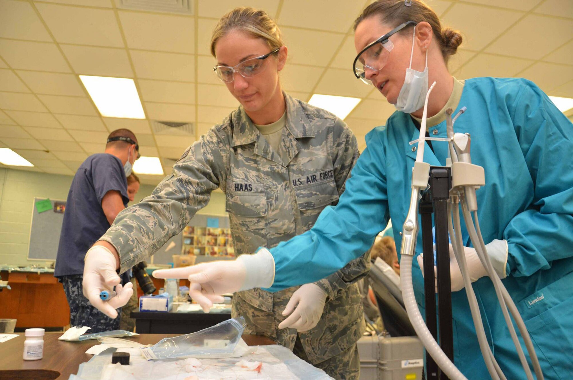 Senior Airman Lindsay Haas (left) from the 180th Fighter Wing in Toledo, Ohio, and Tech. Sgt. Sabrina Woodworth from the 107th Medical Group in Niagara Falls, sort dental equipment prior to procedures at Martin Middle School in Martin, Tenn. Haas and Woodworth, along with more than 40 other Navy Medicine professionals, are participating in the Hope of Martin community outreach project, an Air National Guard-led initiative providing medical care during the Hope of Martin Innovative Readiness Training mission which is designed to train U.S. military medical personnel and provide assistance to underserviced communities. (Air Force Photo by Tech. Sgt. Meghan Skrepenski, Virginia Air National Guard Public Affairs)