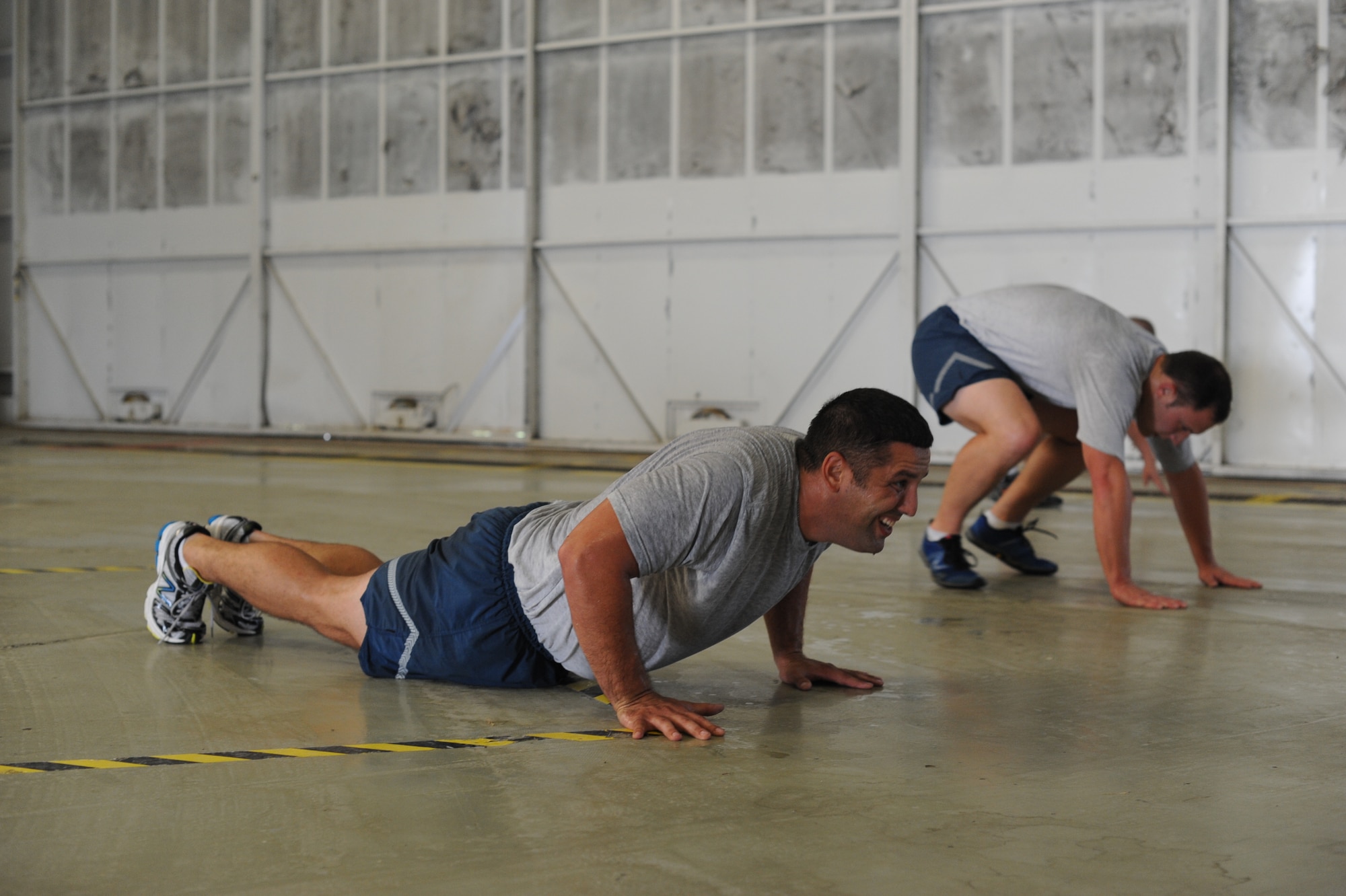Staff Sgt. Thomas Phillips, 305th Maintenance Squadron era of repair technician, performs pushup repetitions during the 305th MXS's Recon physical training program July 18, 2013, at Dock 23, Joint Base McGuire-Dix-Lakehurst, N.J. Recon is a program designed to improve the physical readiness of the members through cardio and strength training. (U.S. Air Force photo by Airman 1st Class Sean M. Crowe/Released)