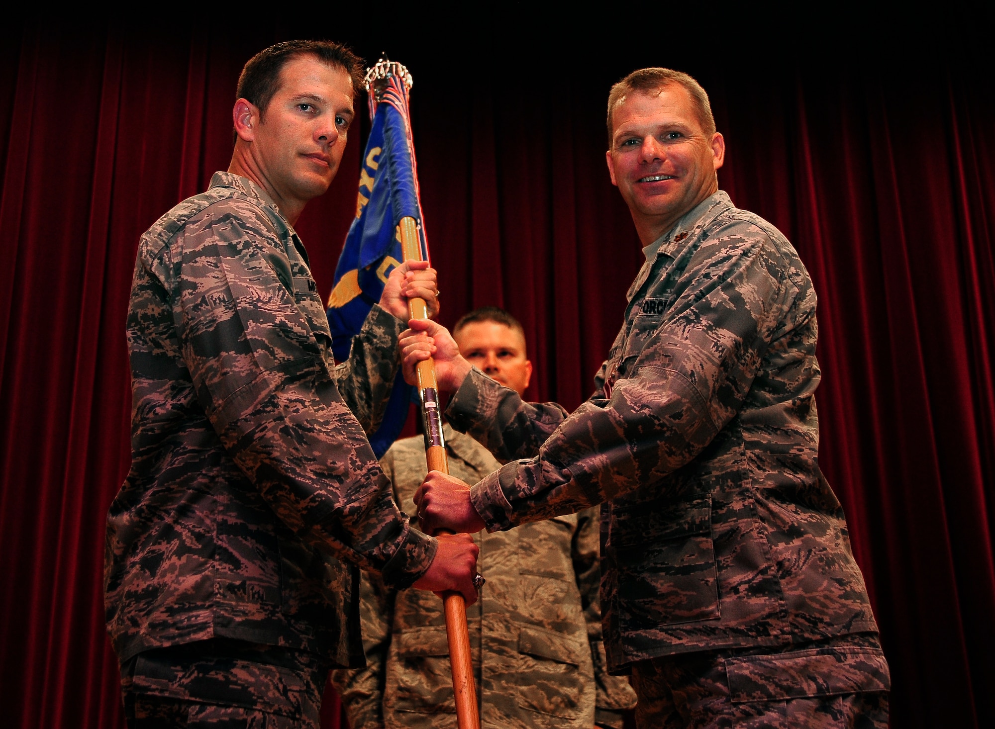 Col. Chase McCown, left, 509th Maintenance Group commander, and Maj. Nathan Bradley, outgoing 509th Maintenance Operations Squadron commander, hold the squadron’s guidon during the 509th MOS inactivation ceremony July 15, 2013, at Whiteman Air Force Base, Mo. Bradley’s next assignment will be at Barksdale Air Force Base, La., as the B-2 Spirit weapons system team chief. (U.S. Air Force photo by Staff Sgt. Brigitte N. Brantley/Released)