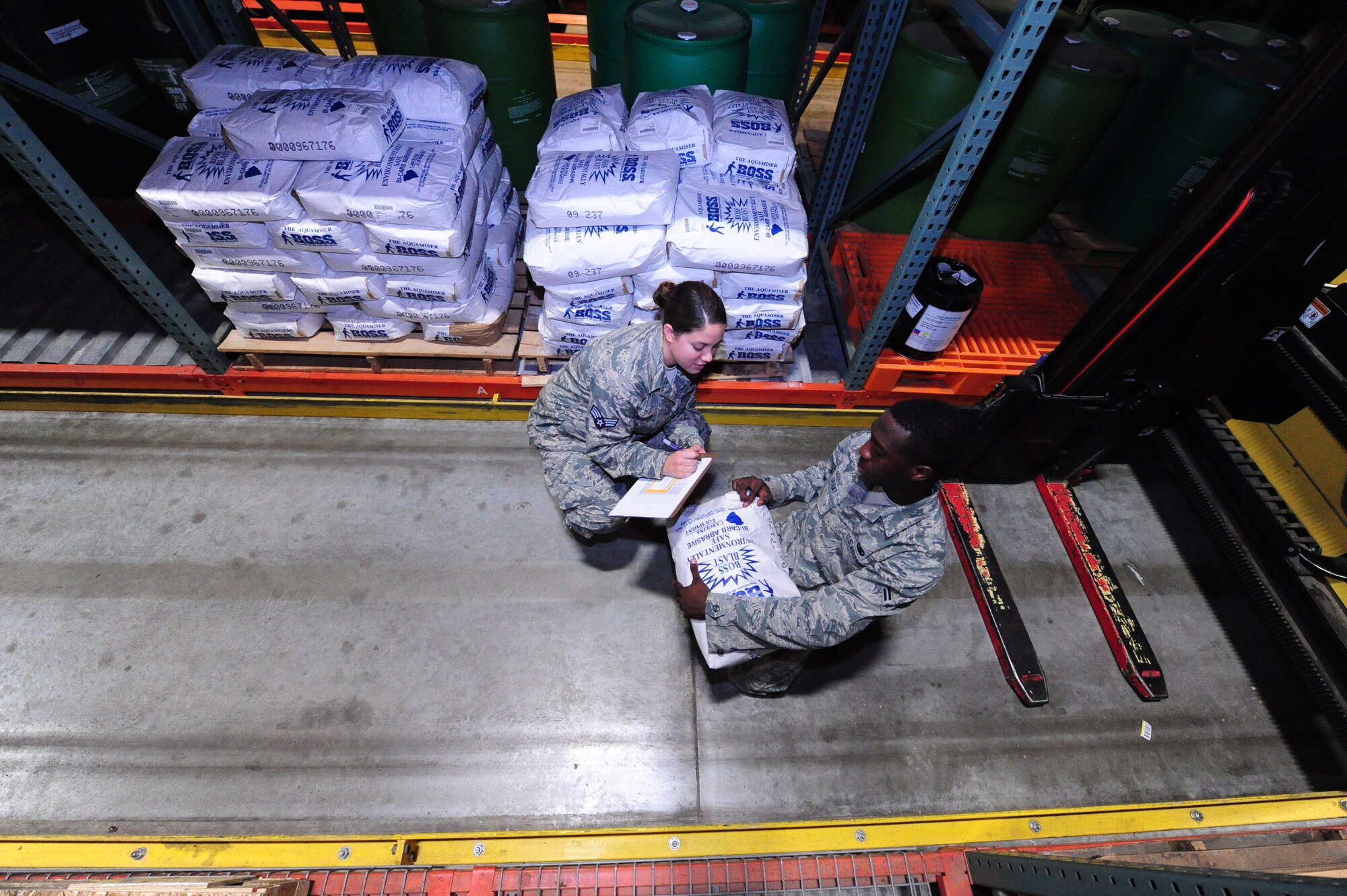 Senior Airman Stephanie Shipwash and Airman 1st Class Terrell Grant and, both 509th Logistics Readiness Squadron central storage journeymen, document batch slot numbers and expiration dates with Airman 1st Class Terrell Grant, at the central storage warehouse at Whiteman Air Force Base, Mo., June 25, 2013. This helps Airmen prioritize items according to shelf-life and expiration dates. All items are handed to customers in “first in, first out” order. (U.S. Air Force photo by Staff Sgt. Nick Wilson/Released) 