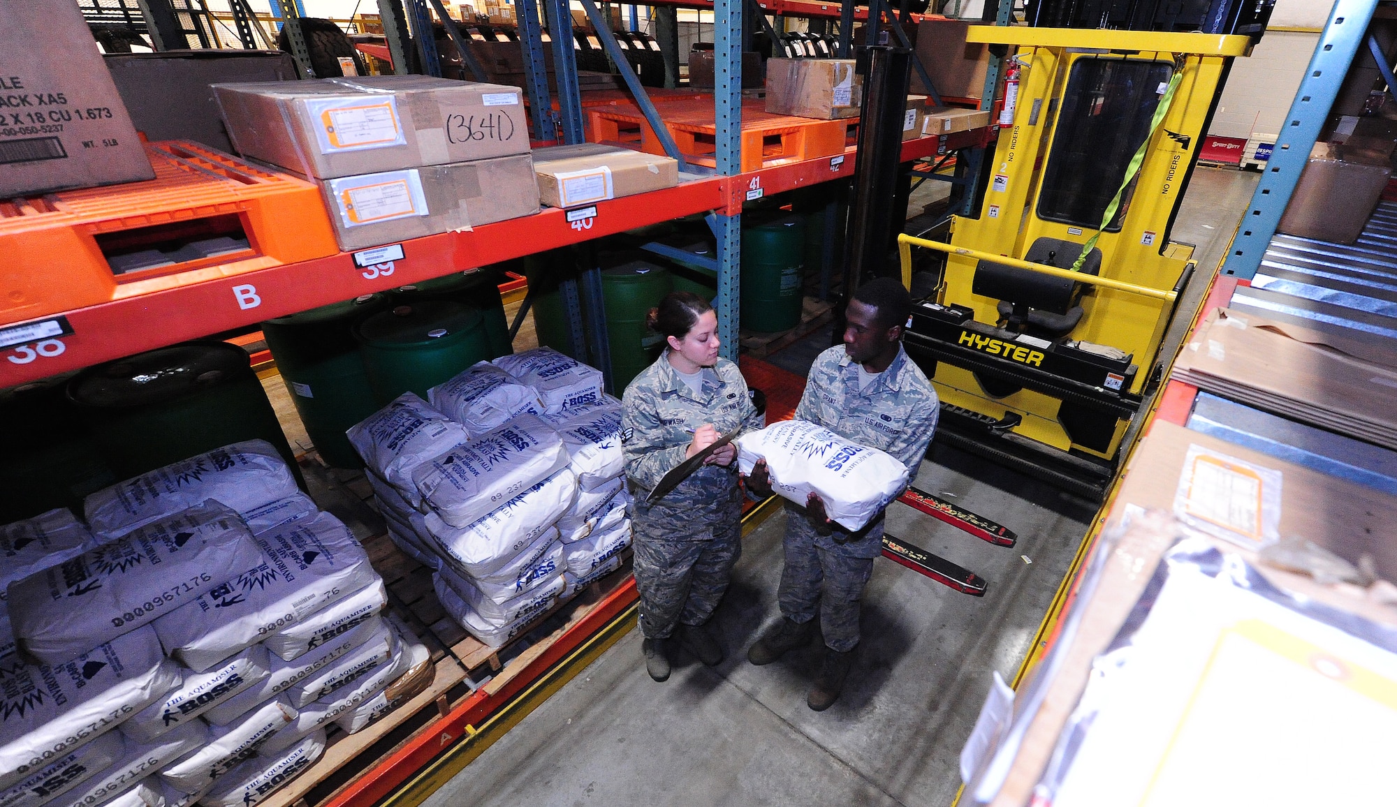 Senior Airman Stephanie Shipwash and Airman 1st Class Terrell Grant and, both 509th Logistics Readiness Squadron central storage journeymen, verify the stock numbers of warehouse items prior to loading it onto a hyster to support a customer request at Whiteman Air Force Base, Mo., June 25, 2013. Checking stock numbers helps central storage technicians ensure they have the right items before handing them out to customers. (U.S. Air Force photo by Staff Sgt. Nick Wilson/Released)