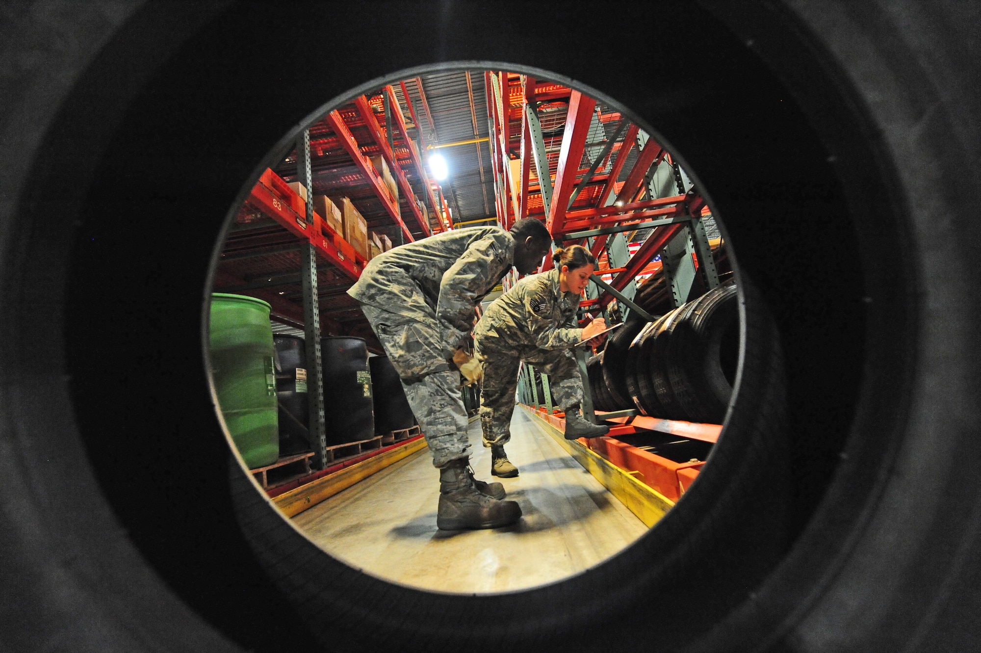 Airman 1st Class Terrell Grant, 509th Logistics Readiness Squadron central storage journeyman, performs warehouse location checks with Senior Airman Stephanie Shipwash, 509th LRS central storage journeyman, at the central storage warehouse at Whiteman Air Force Base, Mo., June 25, 2013. Location checks help Airmen working in the warehouse ensure government property is placed in the proper location on the shelves. (U.S. Air Force photo by Staff Sgt. Nick Wilson/Released)