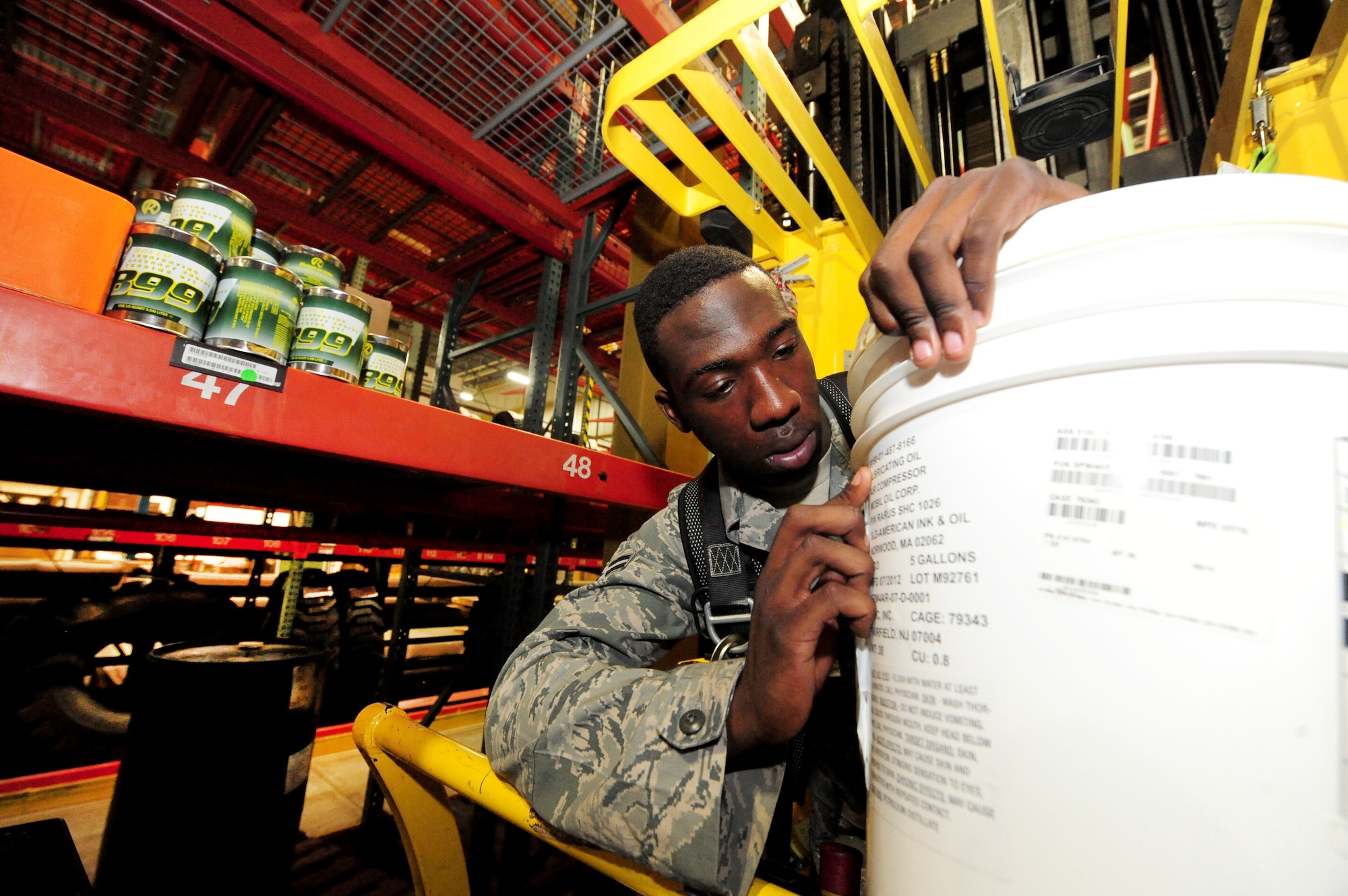 Airman 1st Class Terrell Grant, 509th Logistics Readiness Squadron central storage journeyman, double-checks the stock number of an item before putting it away at the central storage warehouse at Whiteman Air Force Base, Mo., June 25, 2013. Checking stock numbers helps Grant keep accountability of warehouse items. (U.S. Air Force photo by Staff Sgt. Nick Wilson/Released)