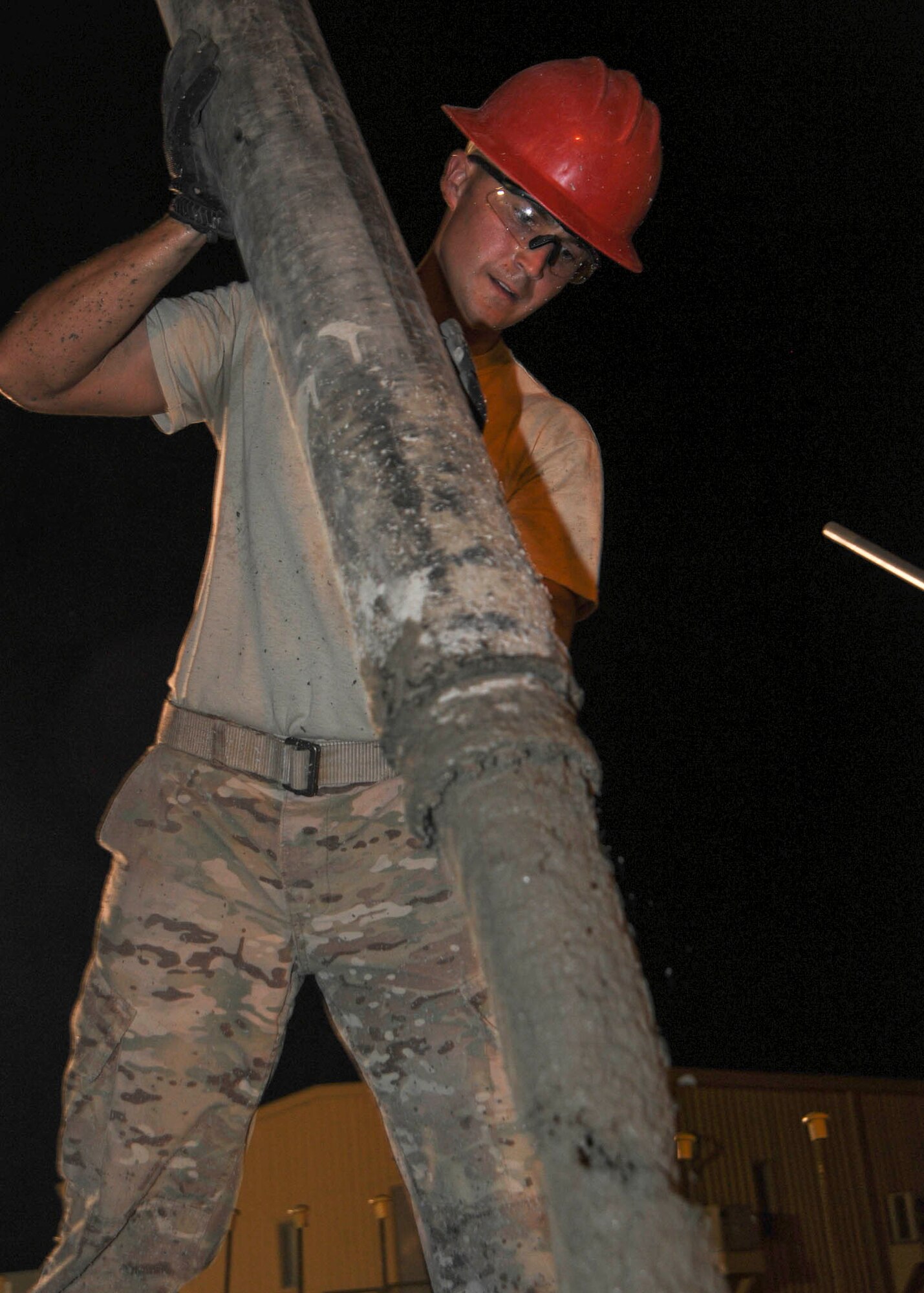 Staff Sgt. Steven Shirley controls the hose pouring concrete at the Contingency Aeromedical Staging Facility building site at the 379th Air Expeditionary Wing in Southwest Asia, July 9, 2013. Shirley is a 557th Expeditionary RED HORSE Squadron structures craftsman deployed from Malstrom Air Force Base, Mont. (U.S. Air Force photo/Senior Airman Bahja J. Jones) 