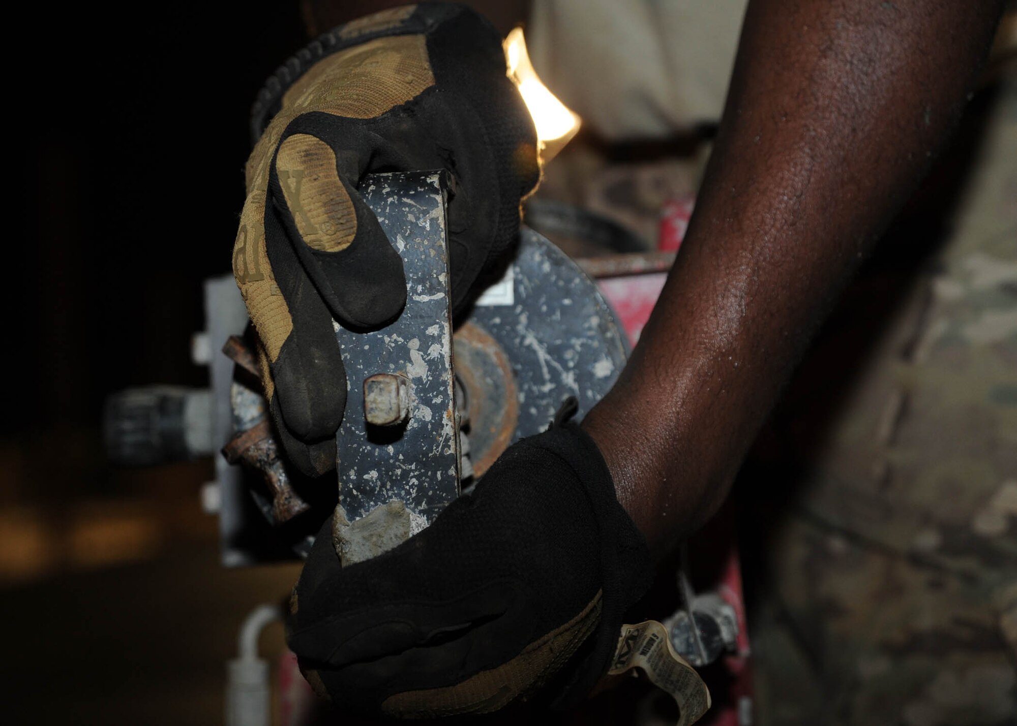 Staff Sgt. Paul Williams tightens the handle on the screed used to smooth and level wet concrete at the 379th Air Expeditionary Wing in Southwest Asia, July 9, 2013. The 557th Expeditionary RED HORSE Squadron supports building and runway projects tasked by the Combined Force Air Component Commander. Williams is a 557th ERHS structural craftsman deployed from Malstrom Air Force Base, Mont. (U.S. Air Force photo/Senior Airman Bahja J. Jones) 