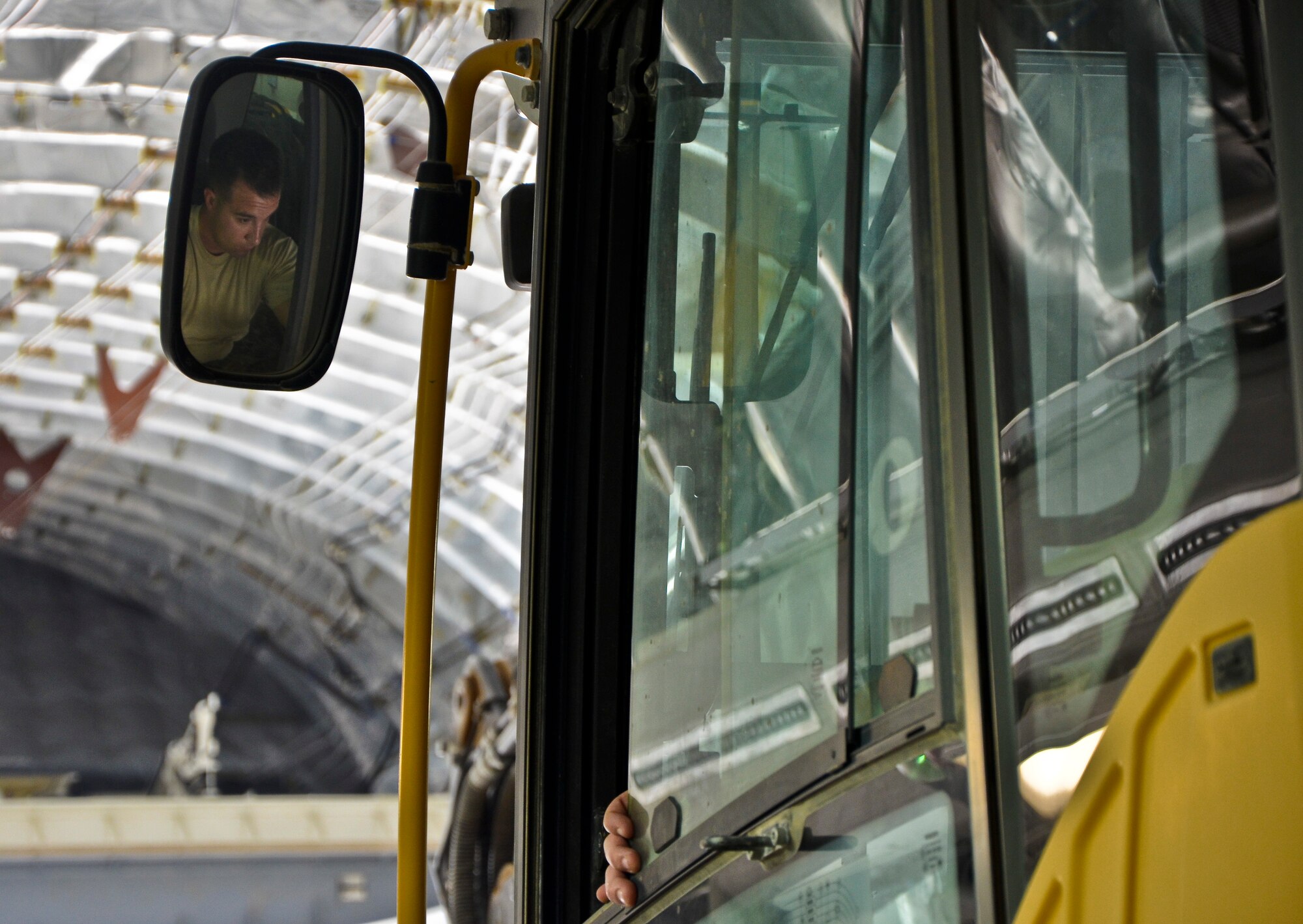 Tech. Sgt. Thomas Wyatt operates an excavator as it is loaded onto a C-17 Globemaster III at the 379th Air Expeditionary Wing in Southwest Asia, July 17, 2013. Wyatt is a 557th Expeditionary RED HORSE Squadron pavement construction equipment craftsman deployed from Malmstrom Air Force Base, Mont. (U.S. Air Force photo/Senior Airman Benjamin Stratton)
