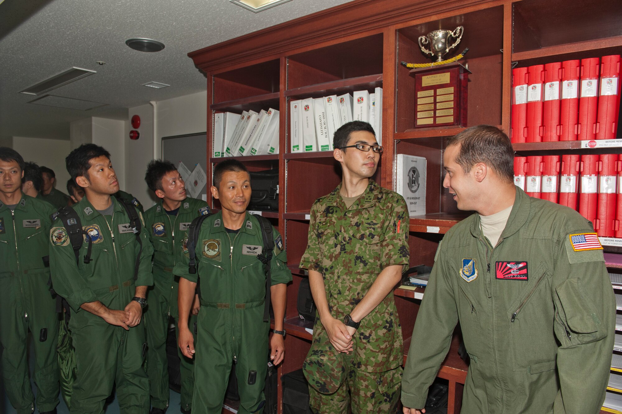 Staff Sgt. Nickolas Alarcon, 36th Airlift Squadron, gives members of the Japan Air Self-Defense Force a squadron tour at Yokota Air Base, Japan, July 12, 2013. Ten JASDF loadmasters, six navigators, two pilots and one engineer made the trip out to Yokota. (U.S. Air Force photo by Senior Airman Michael Washburn)