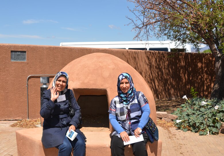 COCHITI LAKE, N.M., -- Two of the visiting water managers stop to appreciate the kiva in front of the Cochiti Lake project office, July 3, 2013.