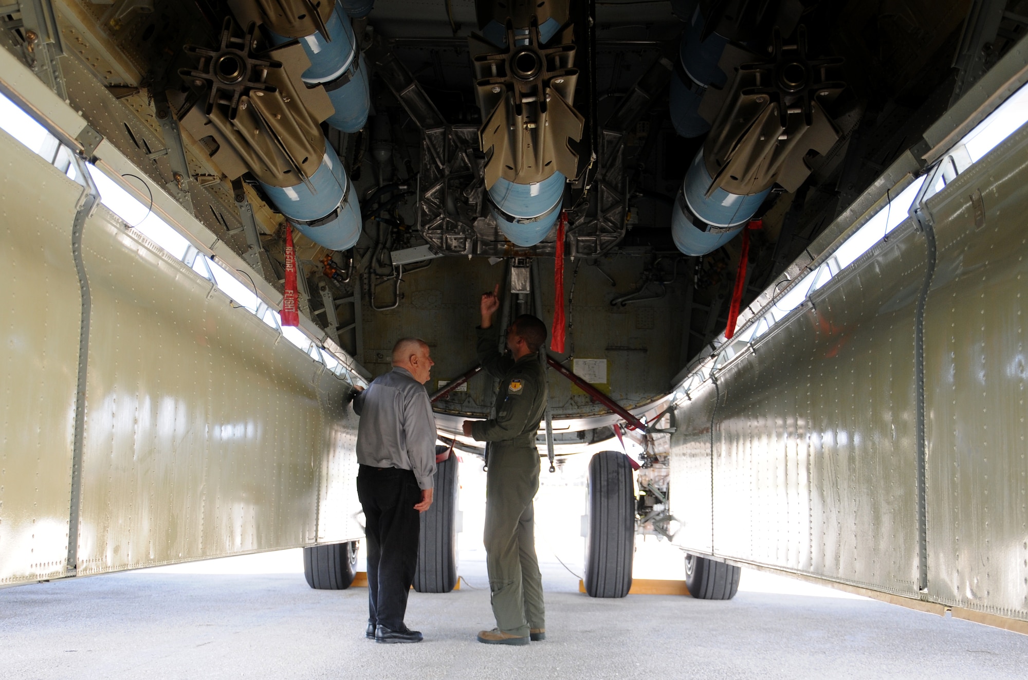 Capt. Mike Sydney, 23rd Expeditionary Bomb Squadron B-52 Stratofortress copilot, explains features of the aircraft to former Marine Pfc. William Mays, a Guam liberation World War II veteran, during his visit to Andersen Air Force Base, Guam, July 17, 2013. Mays visited the 36th Operations Support Squadron, the three Marine units temporarily assigned here, and a B-52 during his weeklong visit to the island for the 69th anniversary of Liberation Day. (U.S. Air Force photos by Staff Sgt. Melissa B. White/Released)