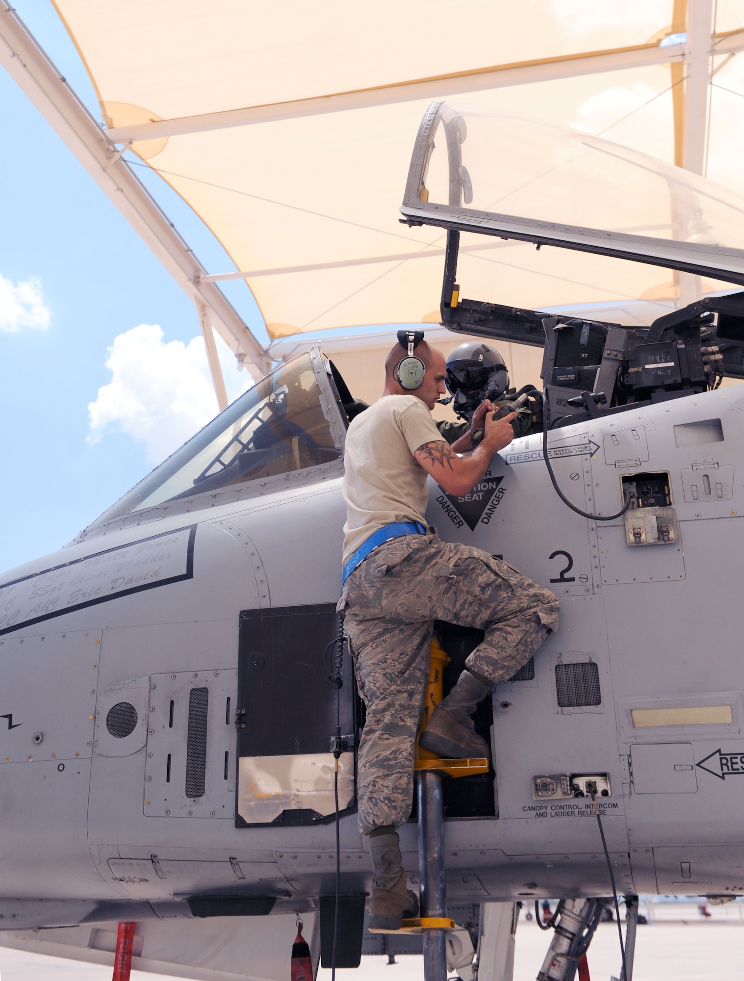 An avionics Airman goes over preflight checks with Maj. Dennis Hargis, 354th FS fighter pilot, before a sortie at Davis-Monthan Air Force Base, Ariz., July 17, 2013. The aircraft maintenance unit assigned to the 354th FS is the 354th AMU, a squadron of more than 200 maintenance Airmen. (U.S. Air Force photo by Airman 1st Class Saphfire Cook/Released)