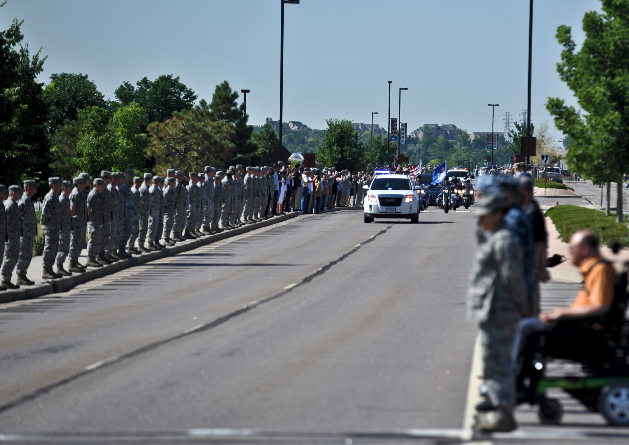 Team Buckley members render a military courtesy to Airman 1st Class Shaquille Hargrove as he is transferred to Denver International Airport en route to his hometown of Wilson, N.C. July 18, 2013, Buckley Air Force Base, Colo. Hargrove, 2nd Space Warning Squadron satellite systems operator, was killed in an incident in downtown Denver July 13. (U.S. Air Force photo by Airman 1st Class Riley Johnson/Released) 