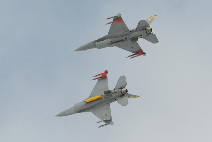 Two F-16s from the 4th Fighter Squadron fly in close proximity in this March 2, 2012, photo. The 4th FS resumed flying July 16 after the Air Force approved the use of $423 million to restore flying hours to units that were stood down in April of this year due to sequestration. (U.S. Air Force photo by Alex R. Lloyd/Released)