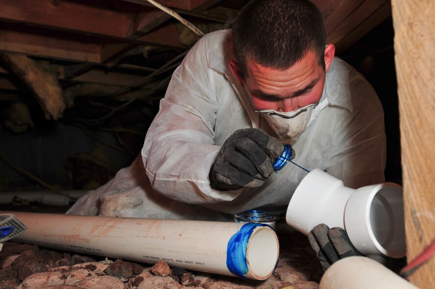 Colorado Air National Guard Senior Airman Cody Elfring, 140th Civil Engineer Squadron, works in the crawl space below a Hogan (a traditional Navajo home that will be used to house families with special needs children)  as a part of the St. Michaels Association for Special Education - Innovative Readiness Training in Window Rock, Ariz., July 9, 2013. SMASE-IRT is an Air National Guard-led, multiservice mission comprised of Active Duty, Reserve, and National Guard members from Army, Navy and Air Force components, focusing on deployment and real-world readiness training. This project will help prepare the service members for wartime missions in a joint-service environment, and simultaneously improve roads, area drainage and water lines, and update the school facilities and existing Hogans for the Navajo Reservations in New Mexico, Arizona and Utah.  (Air National Guard photo by Tech. Sgt. Wolfram M. Stumpf)