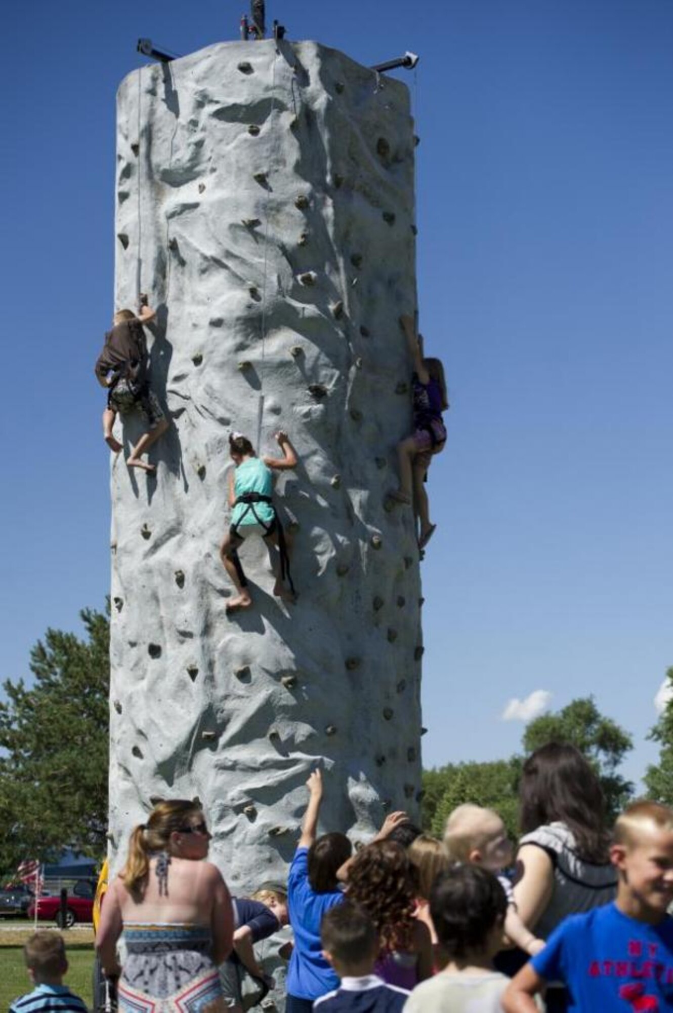 Children climb a rock tower at the 2013 Salute to Our Nation's Defenders Picnic July 12 at Centennial Park. (U.S. Air Force photo by Tech. Sgt. Eric Burks/Released)