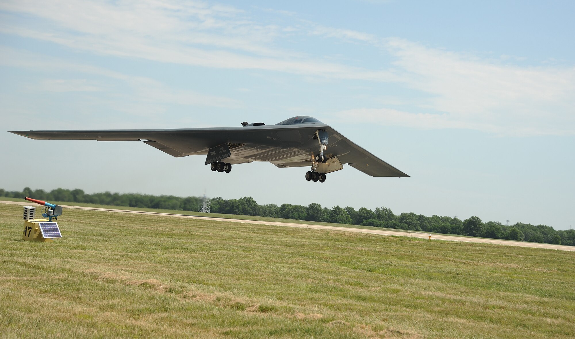 A B-2 Spirit from the 509th Bomb Wing lifts off of the runway as part of a training mission at Whiteman Air Force Base, Mo., July 9, 2013. The B-2 brings massive firepower to bear, in a short time, anywhere on the globe through previously impenetrable defenses. (U.S. Air Force photo by Staff Sgt. Nick Wilson/Released)