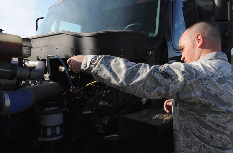 Airman 1st Class Shane Ashton, 2nd Logistics Readiness Squadron fuels distribution, checks the oil of an R-11 fuel truck on Barksdale Air Force Base, La., July 18, 2013. Fuel distribution Airmen work 24 hours a day, seven days a week ensuring the B-52H Stratofortress and all transient aircraft receive the fuel they need to continue their mission. (U.S. Air Force photo/Airman 1st Class Benjamin Gonsier)