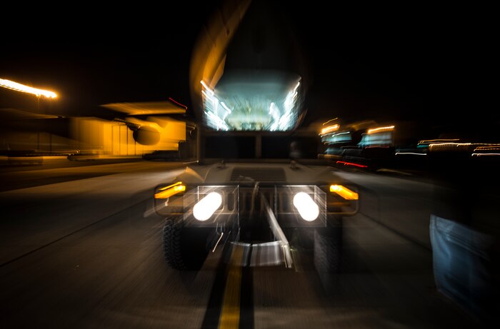 A Humvee is loaded onto a C-17 Globemaster III during an exercise to practice combat on-loading and off-loading July 17, 2013, at Joint Base Charleston – Air Base, S.C. Airmen from the 437th Airlift Wing work around the clock on the flightline to provide combat-ready C-17A aircrews, mission support personnel and processes for 53 assigned aircraft to meet White House, Department of State and Joint Chiefs of Staff-directed global deployment, employment and resupply of Department of Defense and allied forces via air-land and airdrop operations. (U.S. Air Force photo/ Senior Airman Dennis Sloan)