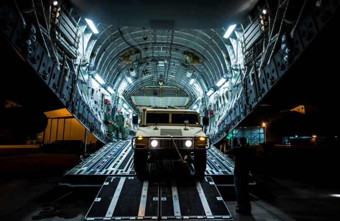 A Humvee is loaded onto a C-17 Globemaster III during an exercise to practice combat on-loading and off-loading July 17, 2013, at Joint Base Charleston – Air Base, S.C. Airmen from the 437th Airlift Wing  work around the clock on the flightline to provide combat-ready C-17A aircrews, mission support personnel and processes for 53 assigned aircraft to meet White House, Department of State and Joint Chiefs of Staff-directed global deployment, employment and resupply of Department of Defense and allied forces via air-land and airdrop operations. (U.S. Air Force photo/ Senior Airman Dennis Sloan)