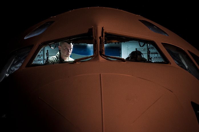 Aircrew members perform pre-flight checks on a C-17 Globemaster III before take-off to practice combat on-loading and off-loading July 17, 2013, at Joint Base Charleston – Air Base, S.C. Airmen from the 437th Airlift Wing work around the clock on the flightline to provide combat-ready C-17A aircrews, mission support personnel and processes for 53 assigned aircraft to meet White House, Department of State and Joint Chiefs of Staff-directed global deployment, employment and resupply of Department of Defense and allied forces via air-land and airdrop operations. (U.S. Air Force photo/ Senior Airman Dennis Sloan)