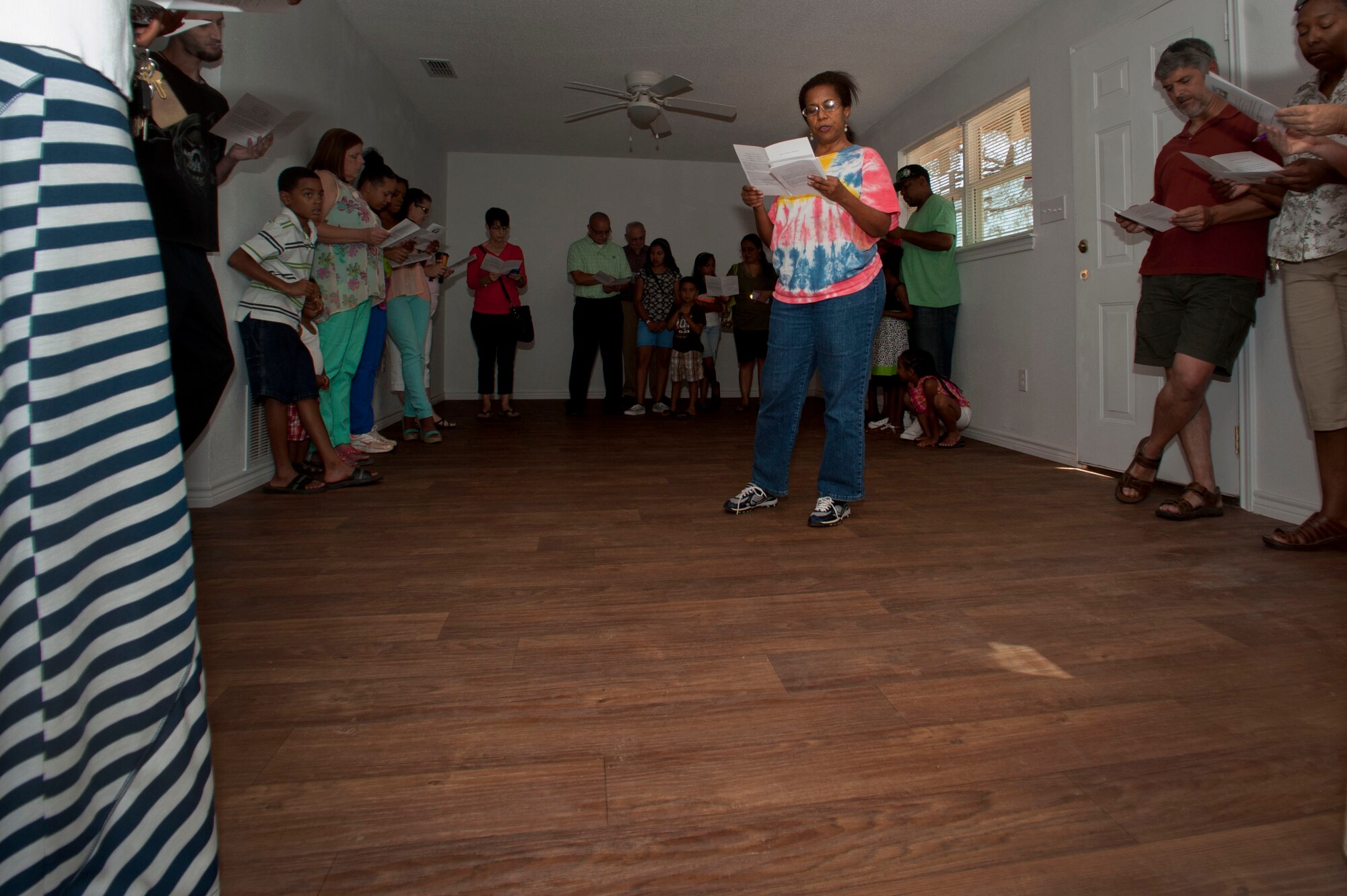 Local residents and participants take part of a dedication ceremony for the houses that were completed July 13. Before each recipient gets a new house they go through financial training and work on other participants’ houses as well. (U.S. Air Force photo by Airman 1st Class Jelani Gibson)  