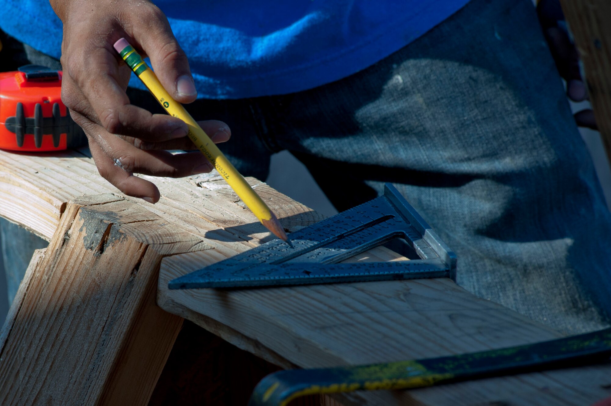 A volunteer measures a block of wood in preparation for construction July 13. Habitat for Humanity has been helping Wichita Falls residents since 1992. (U.S. Air Force photo by Airman 1st Class Jelani Gibson)