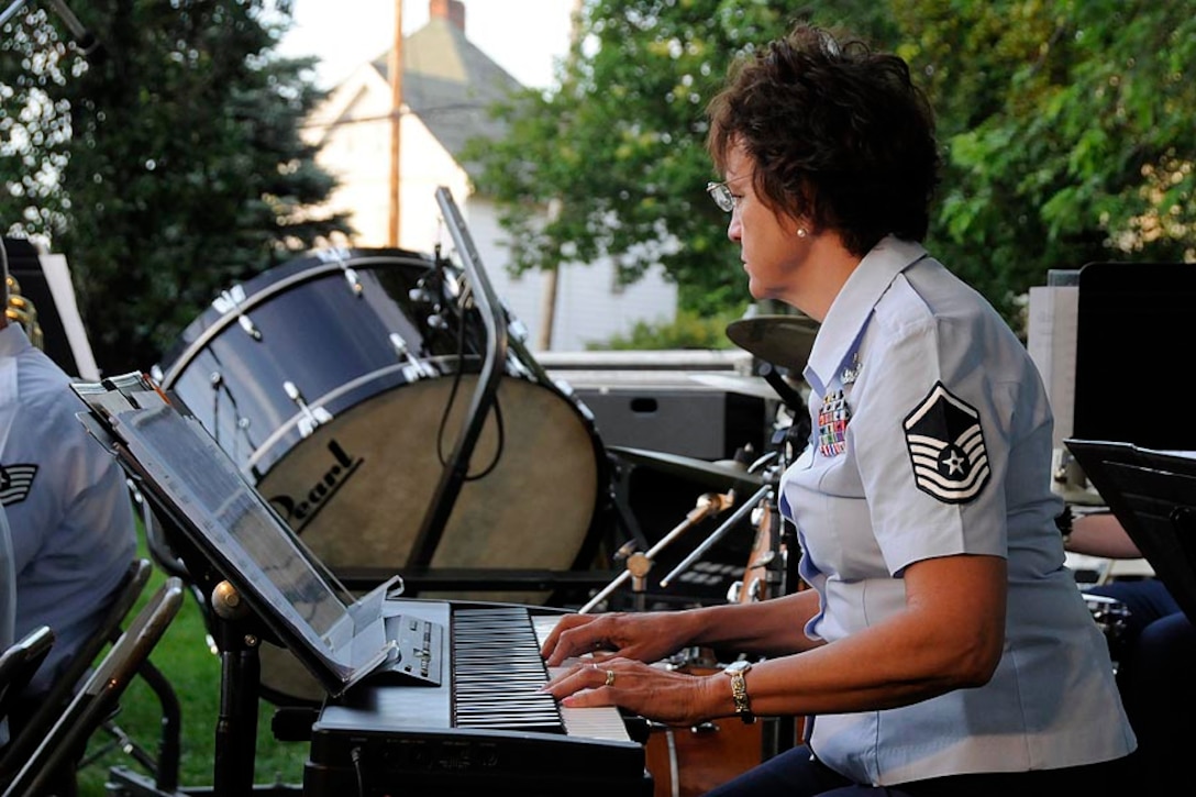 MSgt Dotty deTorres plays piano with the concert band.

Photo courtesy of TSgt Todd Pendleton, 182nd AW Public Affairs