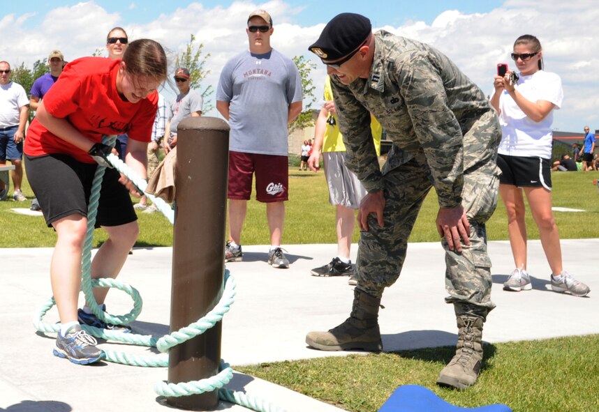 2nd Lt. Amy Bragg, 341st Comptroller Squadron financial services officer, pulls a rope at the strongman competition station during Wing Sports Smackdown at the Grizzly Bend on July 12. Capt. Michael Cheatham, 741st Missile Security Forces Squadron operations officer, refereed the station – a new addition to the quarterly event. (U.S. Air Force photo/Airman 1st Class Collin Schmidt)
