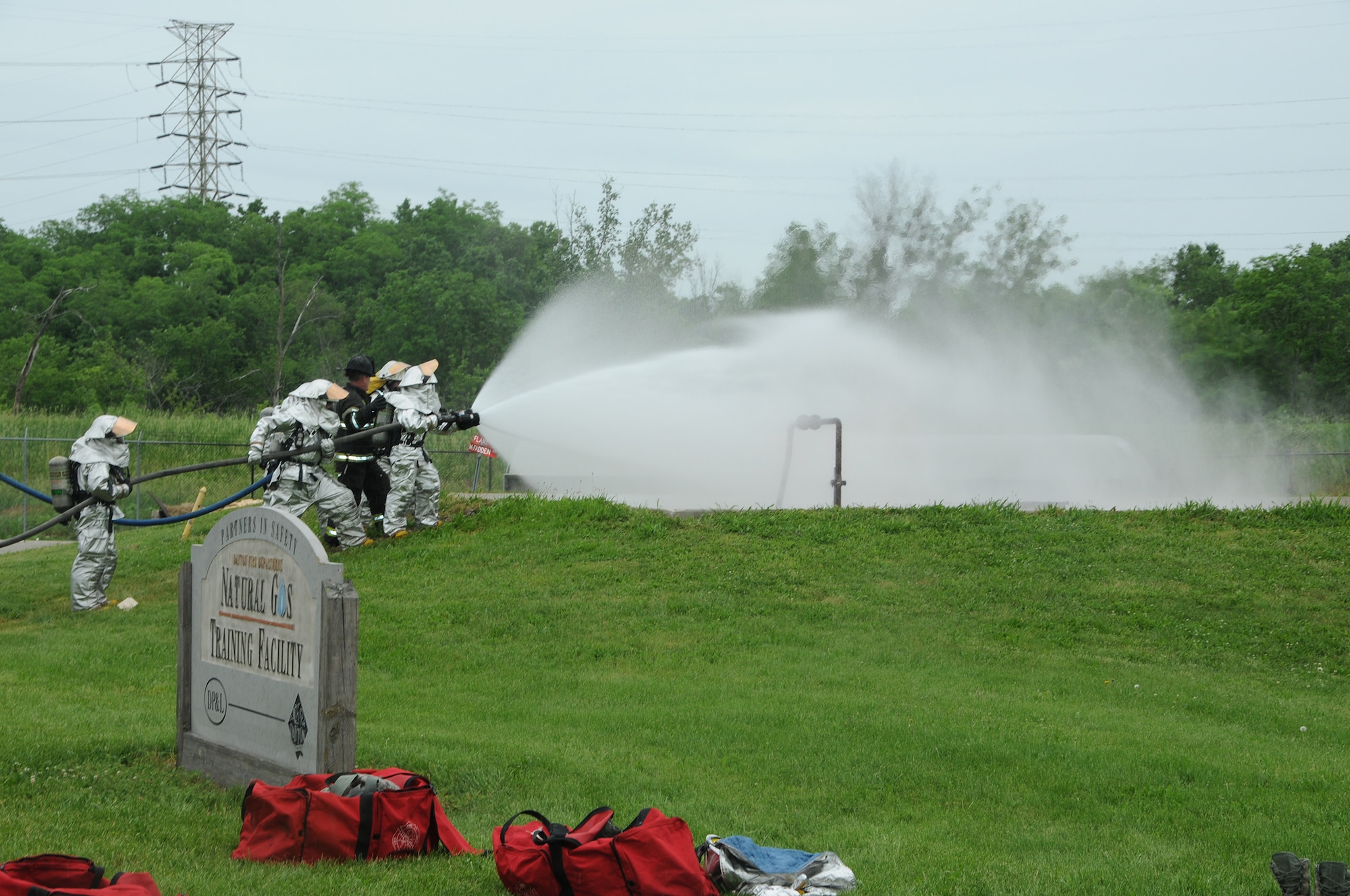 WRIGHT-PATTERSON AIR FORCE BASE, Ohio - Capt. Larry Ables, Dayton Fire Department, instructs firefighters from the 445th Civil Engineer Squadron Fire and Emergency Services Flight on technique as they douse a natural gas leak fire during a training session June 1 at the Dayton Fire Department Training Center. (U.S. Air Force photo/Tech. Sgt. Anthony Springer)