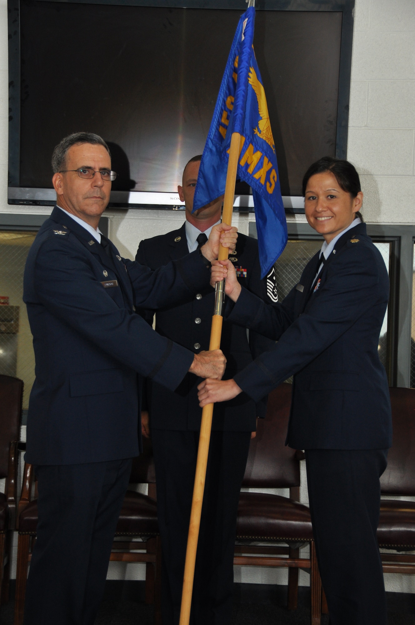U.S. Air Force Maj. Cynthia Vernier assumes command of the 459th Aircraft Maintenance Squadron from U.S. Air Force Col. Donald Robison, 459th Maintenance Group commander, in a change of command ceremony at Joint Base Andrews, Md., July 13, 2013. Vernier was previously the 44th Maintenance Squadron commander at Holloman Air Force Base, N.M., before arriving at the 459 AMXS as a maintenance officer in April of 2013. (U.S. Air Force photo by Staff Sgt. Brent A. Skeen)