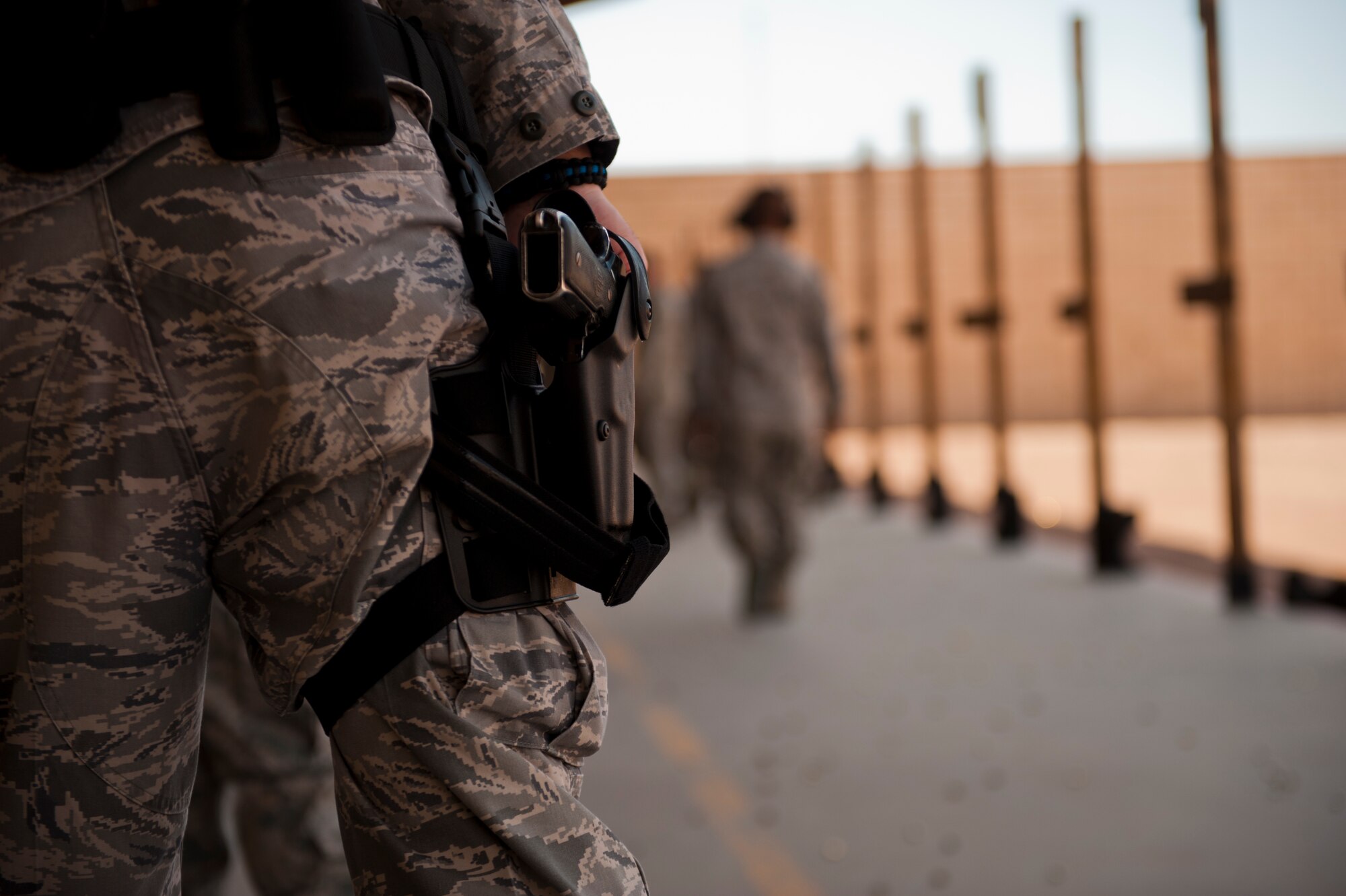 Senior Airman Richard Van Blarcum, 49th Security Forces Squadron patrolman, awaits the final score of his Combat Arms and Maintenance M9 qualification test at Holloman Air Force Base, N.M., July 10. Airmen are scored on the number of targets hit to receive M9 qualification. (U.S. Air Force photo by A1C Aaron Montoya/Released)
