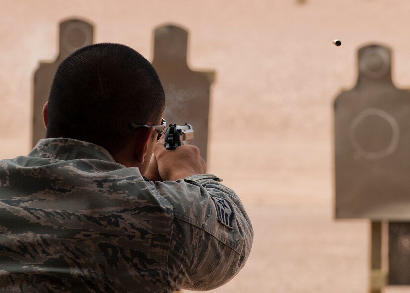 Staff Sgt. Ryan Sablan, 49th Security Forces Squadron patrolman, fires his M9 pistol at a target during a Combat Arms and Maintenance qualification test at Holloman Air Force Base, N.M., July 10. The training Airmen receive at Holloman’s CATM range ensures they are capable and confident when handling their weapon. (U.S. Air Force photo by A1C Aaron Montoya/Released)