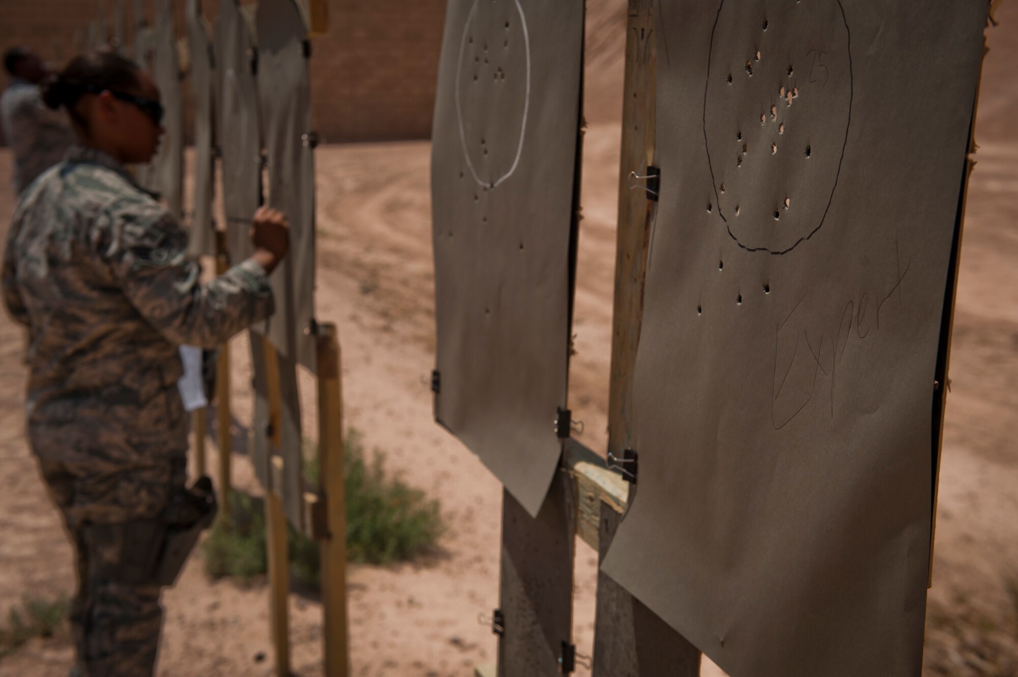 Staff Sgt. Aisha McClain, 49th Security Forces Squadron Combat Arms Training and Maintenance instructor, counts target hits to determine if the shooter qualified at Holloman Air Force Base, N.M., July 10. The training Airmen receive at Holloman’s CATM range ensures they are capable and confident when handling their weapon. (U.S. Air Force photo by A1C Aaron Montoya/Released)