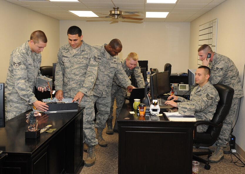 Airmen from the 2nd Communications Squadron executive communications flight conduct information technology service and maintenance on Barksdale Air Force Base, La., July 12, 2013. The executive communications flight is available 24 hours a day, seven days a week to support the senior leaders when their information technology malfunctions. (U.S. Air Force photo/Airman 1st Class Benjamin Gonsier)