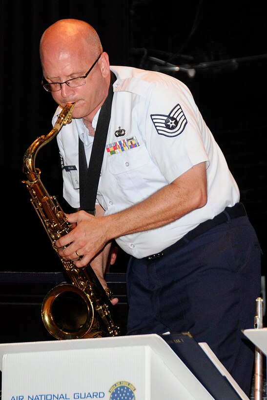 TSgt Paul Holzen stands to solo during the performance.

Photo courtesy of TSgt Todd Pendleton, 182nd AW Public Affairs