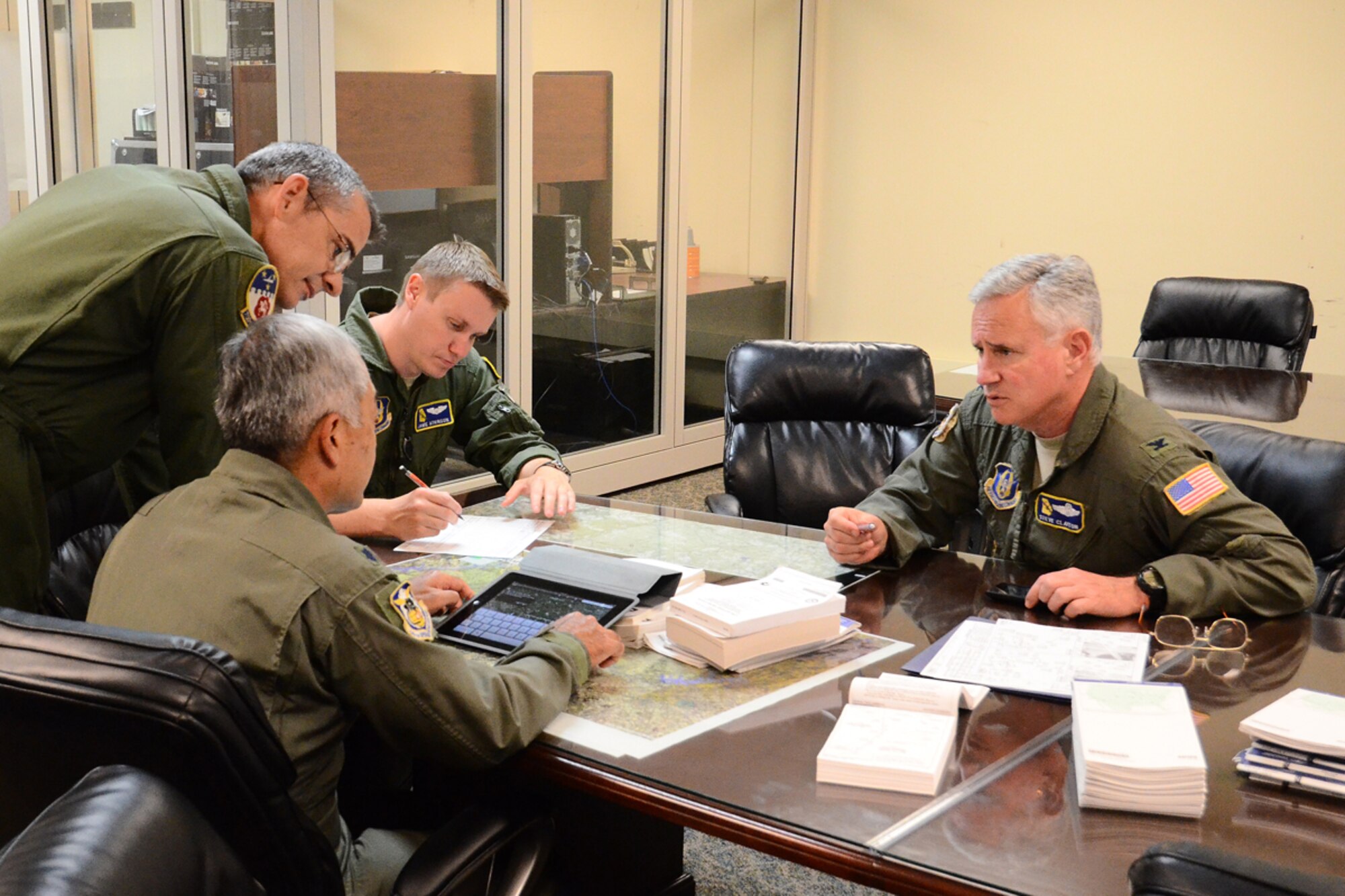 Aircrew members from the 700th Airlift Squadron brief Clayton on the flightplan for his final C-130 flight at Dobbins. Clayton retired after 30 years of service to the U.S. Air Force June 28. Since 2006, Clayton has managed more than 260 military and civilian personnel, eight C-130 aircraft and a multi-million dollar budget to accomplish the wing’s mission of providing qualified C-130 aircrew members for worldwide mobility.. (U.S. Air Force photo/ Brad Fallin)