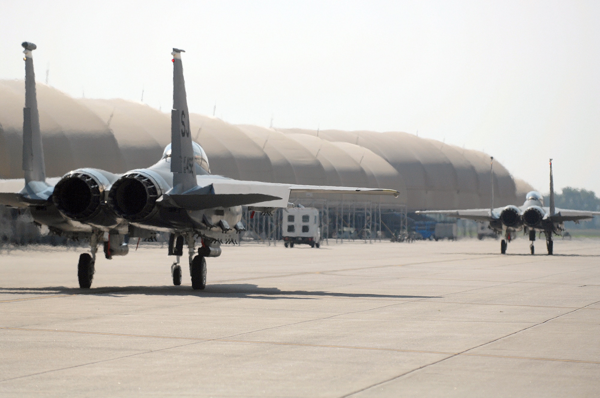 Two F-15E Strike Eagles assigned to the 336th Fighter Squadron taxi to the runway at Seymour Johnson Air Force Base, N.C., July 17, 2013.  Their takeoffs mark the first flights for the squadron since Air Combat Command mandated that the unit stand down due to budget cuts in April 2013.  (U.S. Air Force photo by Airman 1st Class Brittain Crolley/Released)
