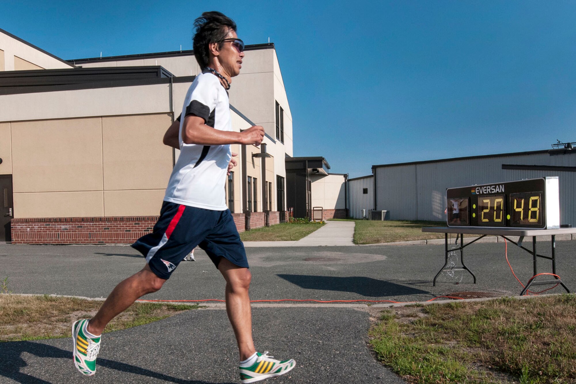 HANSCOM AIR FORCE BASE, Mass. – Masashi Nishida, Battle Management Directorate, crosses the finish line at the Fitness and Sports Center’s Summer Thunder 5k fun run July 17. The top finishers in the male category were Philip Evans, MIT Lincoln Labs, 18:22; Adam Hendrie, U.S. Navy, 19:25 and the top female finishers were Rachael Paepke, Battle Management Directorate, 22:17; Karla Diene, Battle Management Directorate, 25:38. (U.S. Air Force photo by Walter Santos)
