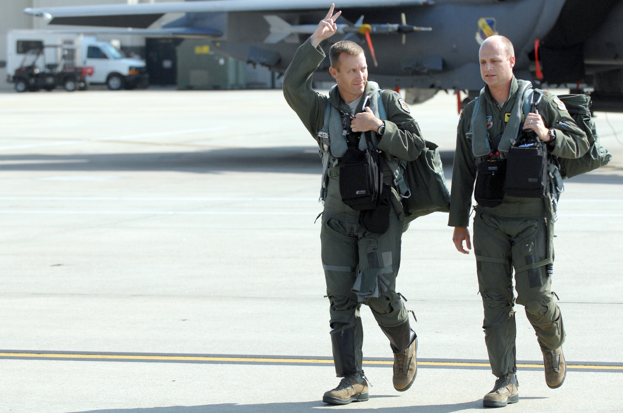 U.S. Air Force Lt. Col. James Howard, 336th Fighter Squadron commander, and Maj. Christopher Troyer, 336th FS pilot, step to the flightline at Seymour Johnson Air Force Base, N.C., July 17, 2013. The flight marks an end to the 100-day layoff from flying due to sequestration.  (U.S. Air Force photo by Airman 1st Class Brittain Crolley/Released)