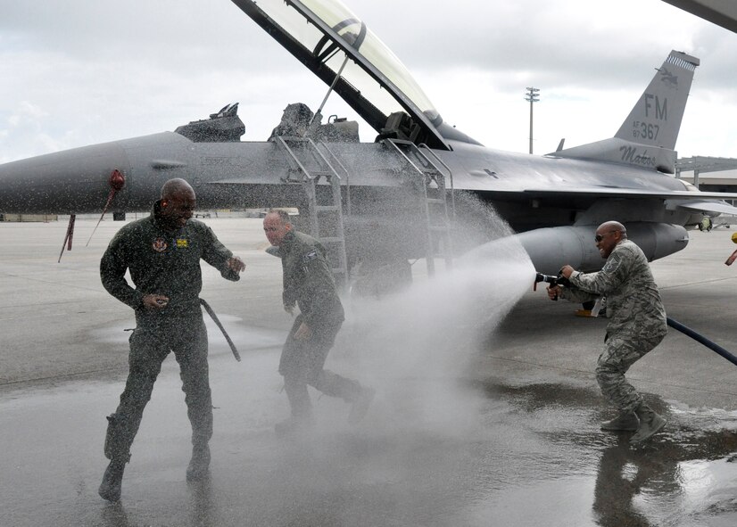 Chief Master Sgt. Cameron B. Kirksey, Air Force Reserve Command command chief master sergeant, gets hosed down by Chief Master Sgt. Katdo Robinson, 482nd Maintenance Squadron superintendent, after his F-16 familiarization flight with Col. Donald R. Lindberg, 10th Air Force vice commander, at Homestead Air Reserve Base, Fla., July 12. (U.S. Air Force photo/Tech. Sgt. Lou Burton)