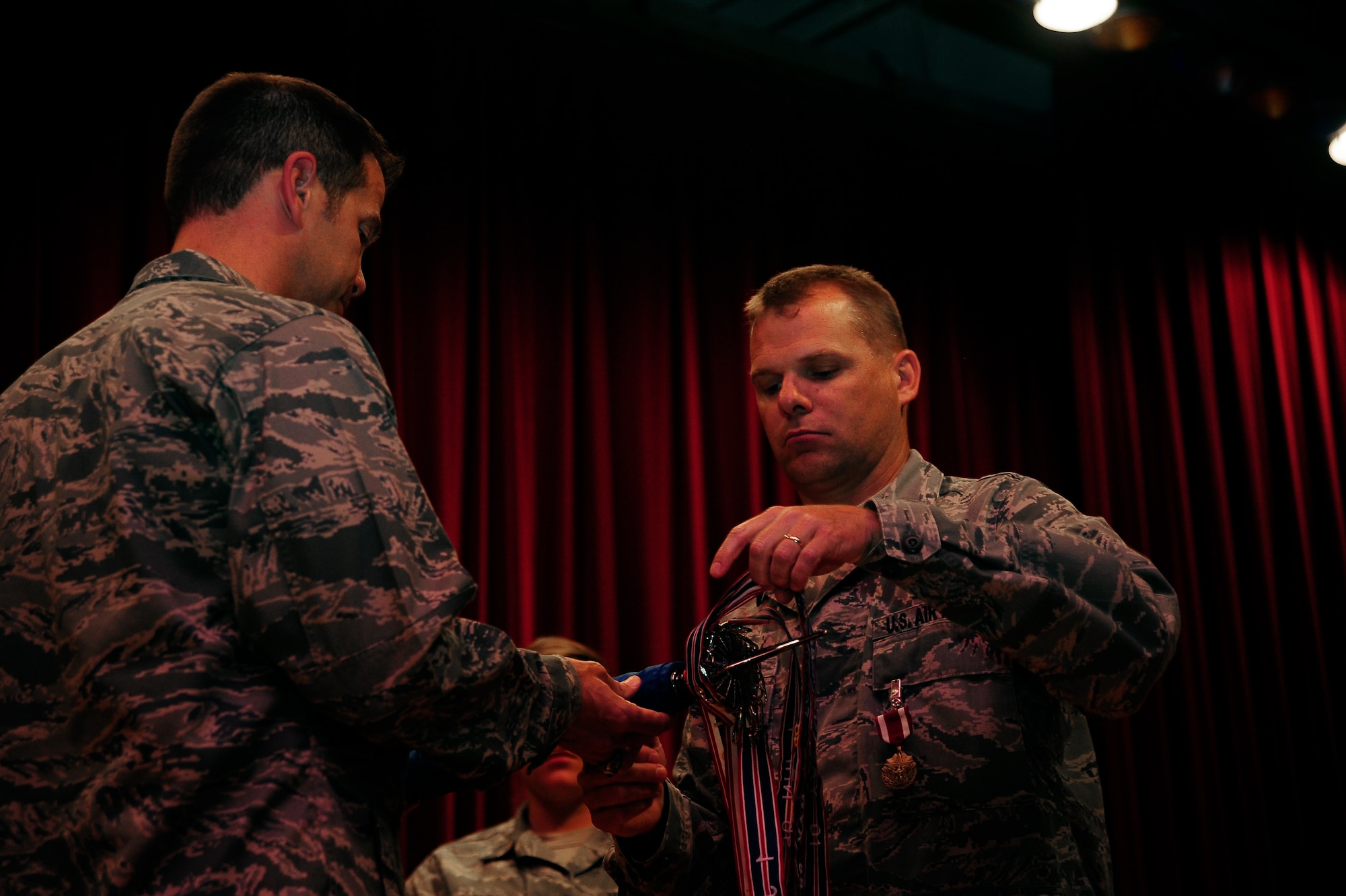 Col. Chase McCown, left, 509th Maintenance Group commander, and Maj. Nathan Bradley, 509th Maintenance Operations Squadron commander, furl the squadron’s guidon during the 509th MOS inactivation ceremony July 15, 2013, at Whiteman Air Force Base, Mo. MOS units across the Air Force are realigning so the career field’s officers can be assigned to best fulfill operational requirements. (U.S. Air Force photo by Staff Sgt. Brigitte N. Brantley/Released)