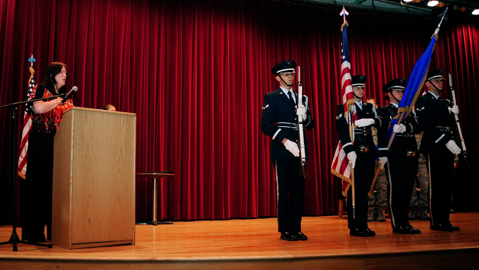 Linda Reiling, 509th Maintenance Group, sings the national anthem as the 509th Bomb Wing Honor Guard presents the colors at the 509th Maintenance Operations Squadron inactivation ceremony July 15, 2013, at Whiteman Air Force Base, Mo. All personnel previously assigned to the squadron will now perform administrative functions underneath the 509th MXG. (U.S. Air Force photo by Staff Sgt. Brigitte N. Brantley/Released)