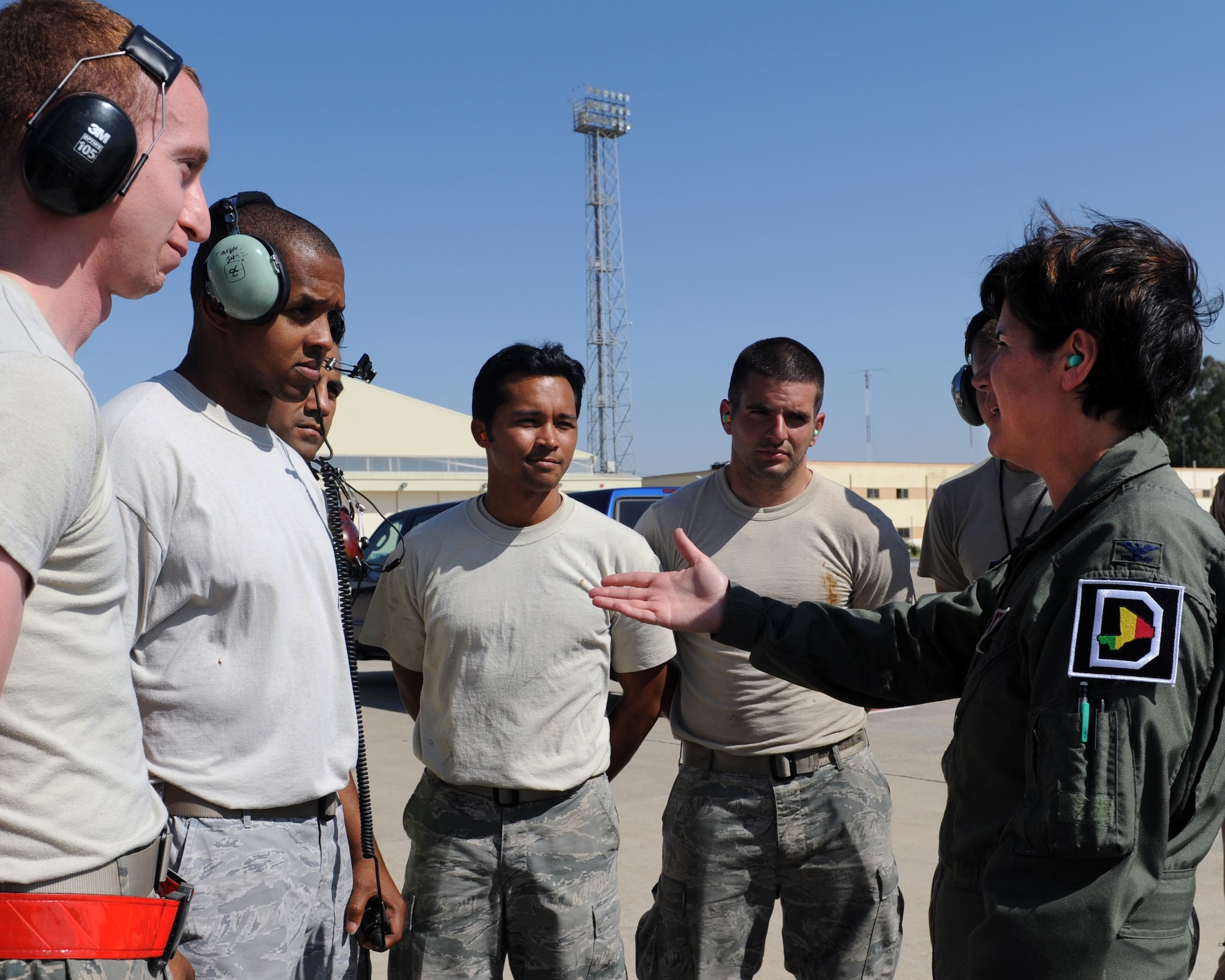 From Left, Airman 1st Class Joshua Simring, Tech. Sgt. Leonardo Riley, Tech. Sgt. Eugene Marques, and Staff Sgt. Nicholas Carone, all 100th Maintenance Group Airmen, receive compliments from Col. Nancy Bozzer, 100th Operations Group commander, July 16, 2013, at Moron Air Base, Spain. On her visit to the base, Bozzer honored distinguished, hard-working Airmen by presenting them each a coin. (U.S. Air Force photo by Airman 1st Class Preston Webb/Released)