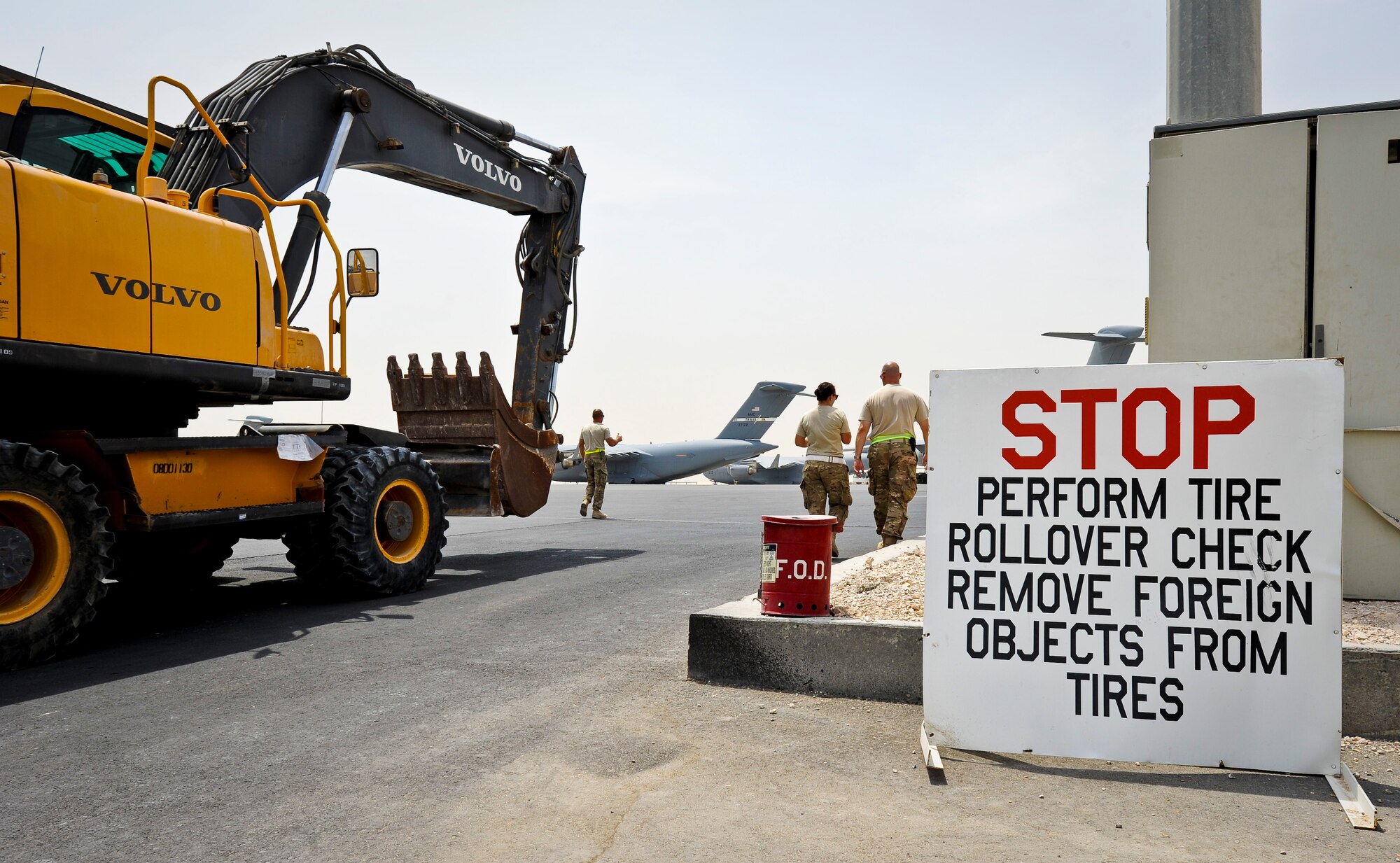 After performing a foreign object check on its tires, an excavator is moved to a C-17 Globemaster III at the 379th Air Expeditionary Wing in Southwest Asia, July 17, 2013. The C-17 will fly the heavy equipment to a forward operating location in Afghanistan where 1st Expeditionary Civil Engineer Group units will use it to support ongoing Operation Enduring Freedom missions. (U.S. Air Force photo/Senior Airman Benjamin Stratton)