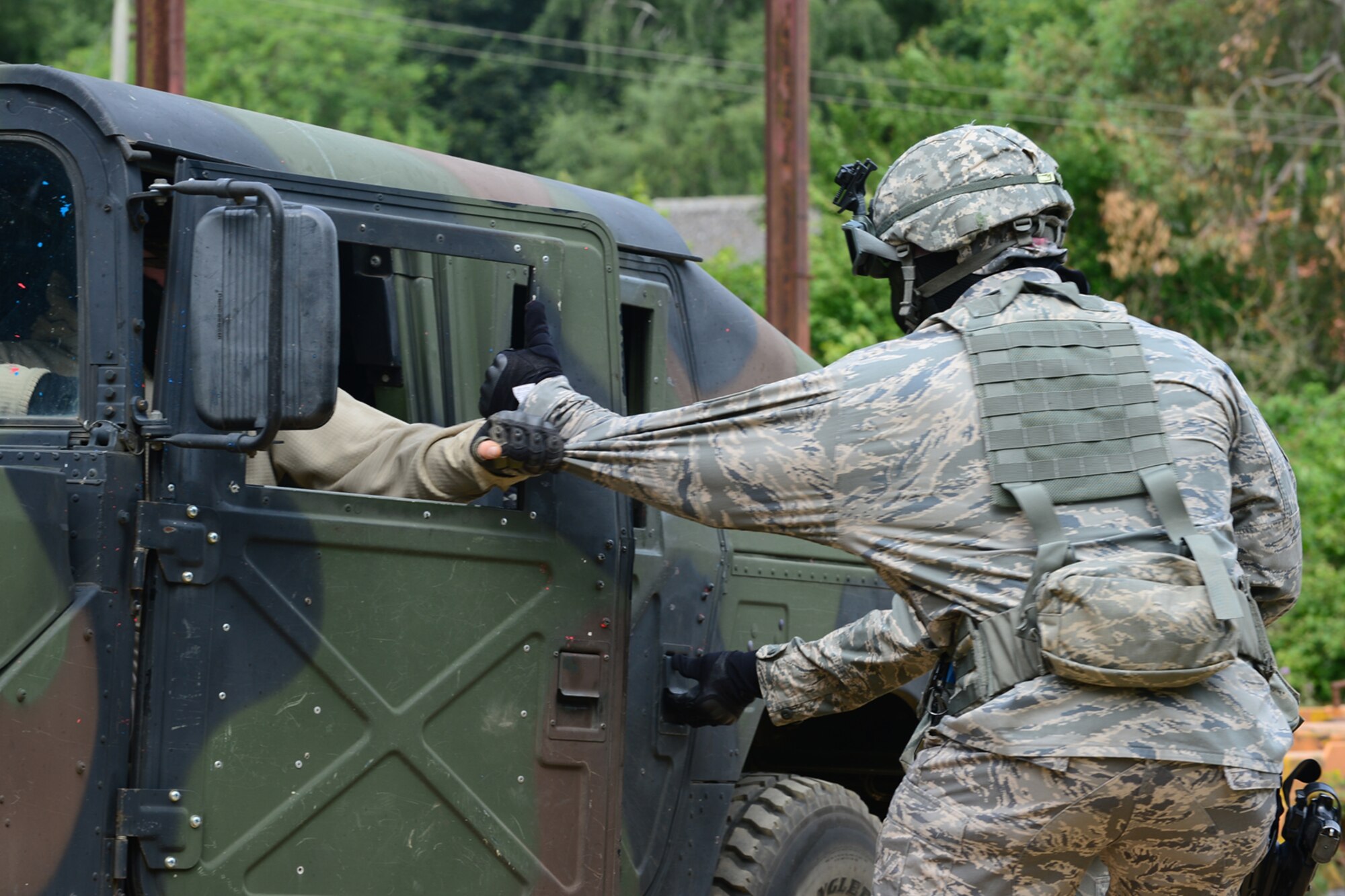 STANFORD TRAINING AREA, England – Master Sgt. Lamount Goodwin, 48th Security Forces Squadron flight chief, struggles with opposing forces during training at the Stanford Training Area in Norfolk, July 11, 2013. Members from the 48th SFS conducted a three-day force-on-force training exercise at STANTA, an area that offers a realistic environment to help train Airmen. Defenders from the 100th SFS, RAF Mildenhall, assisted this training by playing as opposing forces. (U.S. Air Force photo by Airman 1st Class Dana J. Butler)