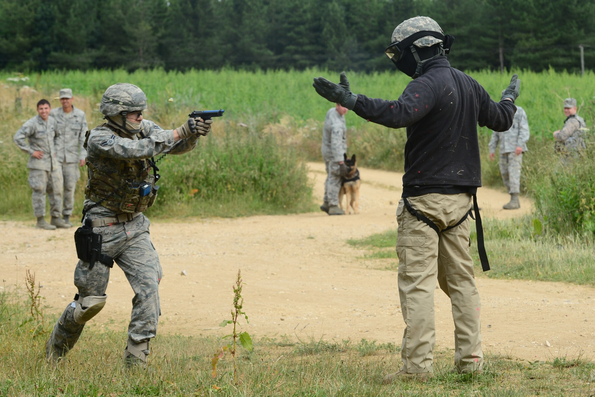 STANFORD TRAINING AREA, England – Airman 1st Class Paul Rhee, 48th Security Forces Squadron response force leader, confronts Senior Airman Adam Shipley, 100th SFS response force member, RAF Mildenhall, who is acting as an opposing force during force-on-force training at the Stanford Training Area in Norfolk, July 11, 2013. Members from the 48th SFS conducted a three-day training exercise at STANTA, an area that offers a realistic environment to help train Airmen. Defenders from the 100th SFS, RAF Mildenhall, assisted this training by playing as opposing forces. (U.S. Air Force photo by Airman 1st Class Dana J. Butler)