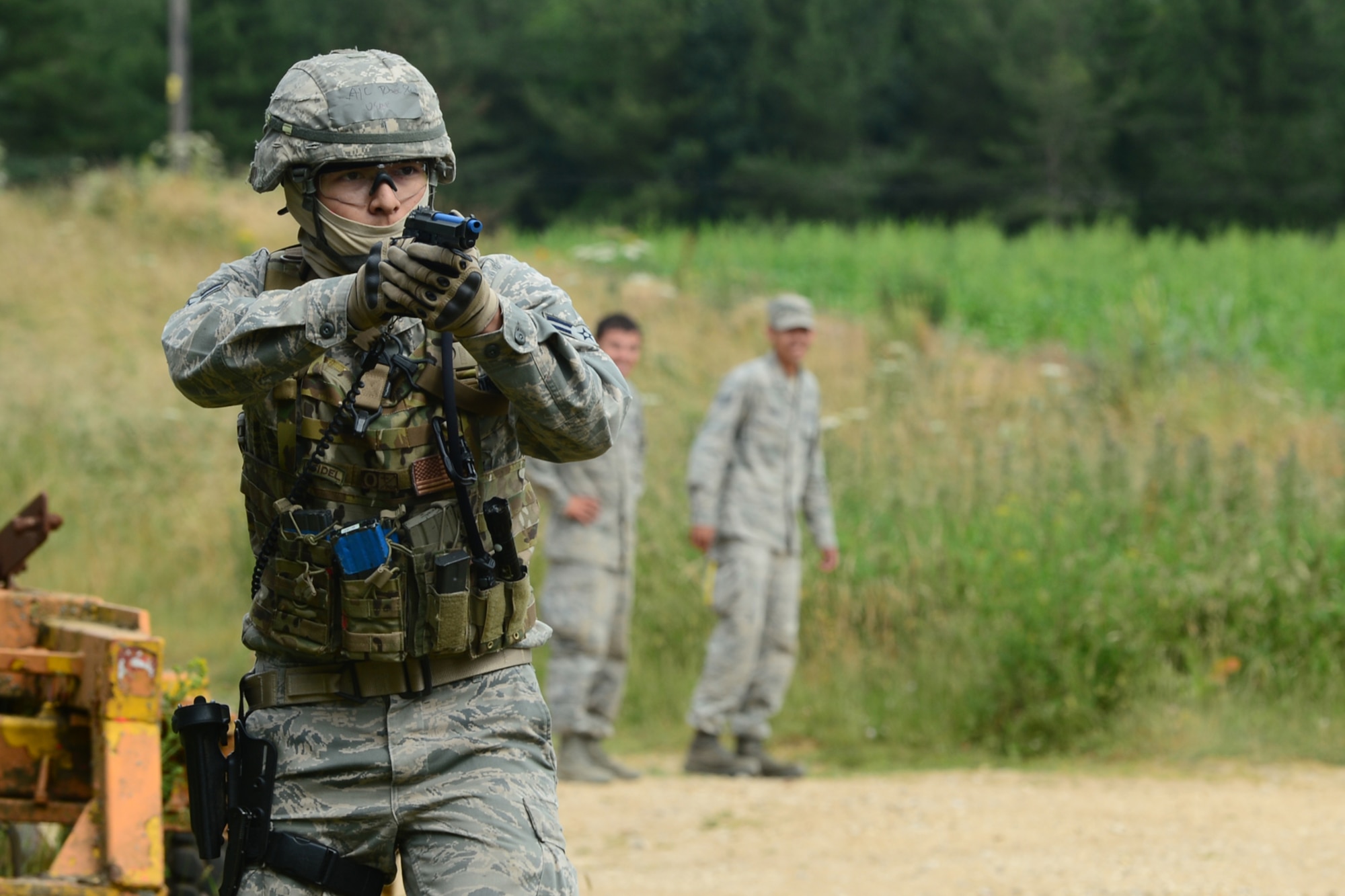 STANFORD TRAINING AREA, England – Airman 1st Class Paul Rhee, 48th Security Forces Squadron response force leader, draws his weapon during force-on-force training at the Stanford Training Area in Norfolk, July 11, 2013. Members from the 48th SFS conducted a three-day training exercise at STANTA, an area that offers a realistic environment to help train Airmen. Defenders from the 100th SFS, RAF Mildenhall, assisted this training by playing as opposing forces. (U.S. Air Force photo by Airman 1st Class Dana J. Butler)